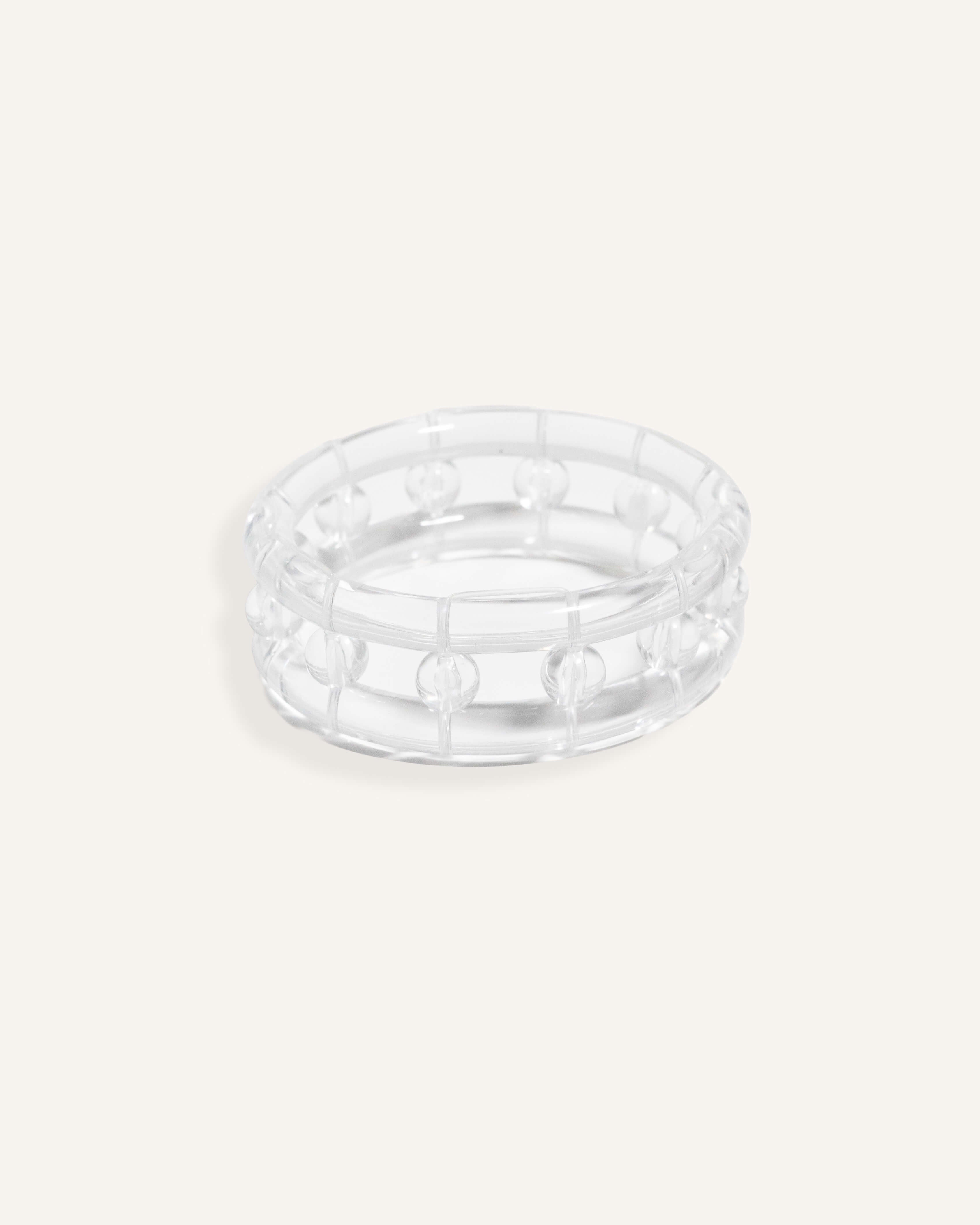 Clear resin bracelet with raised bubbles and a rounded form