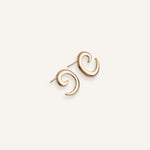 Gold plated spiral earrings with sculptural curved design, shown front facing.