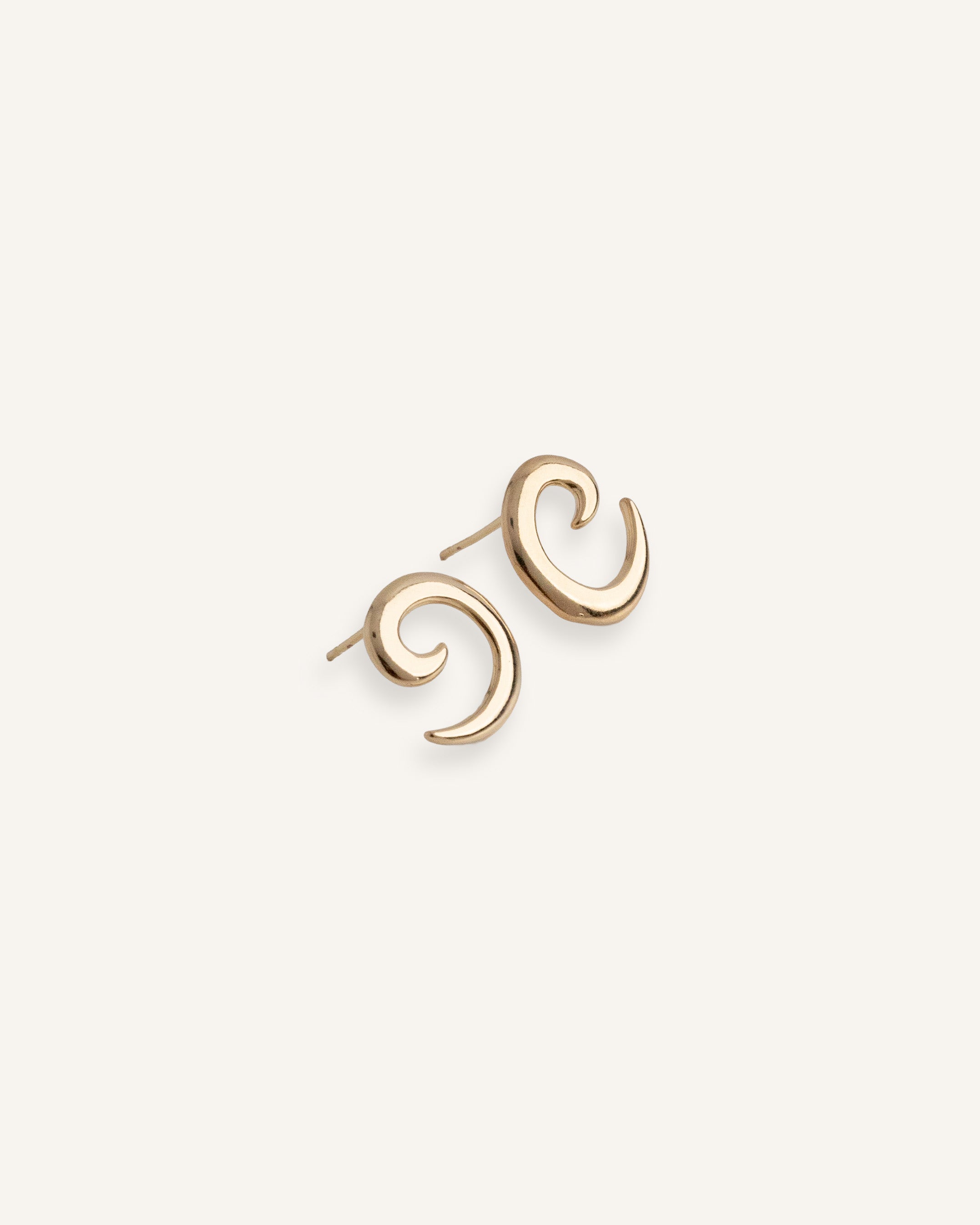 Gold plated spiral earrings with sculptural curved design, shown front facing.