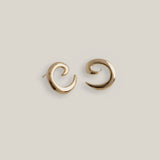 Gold plated spiral earrings with sculptural curved design, shown front facing