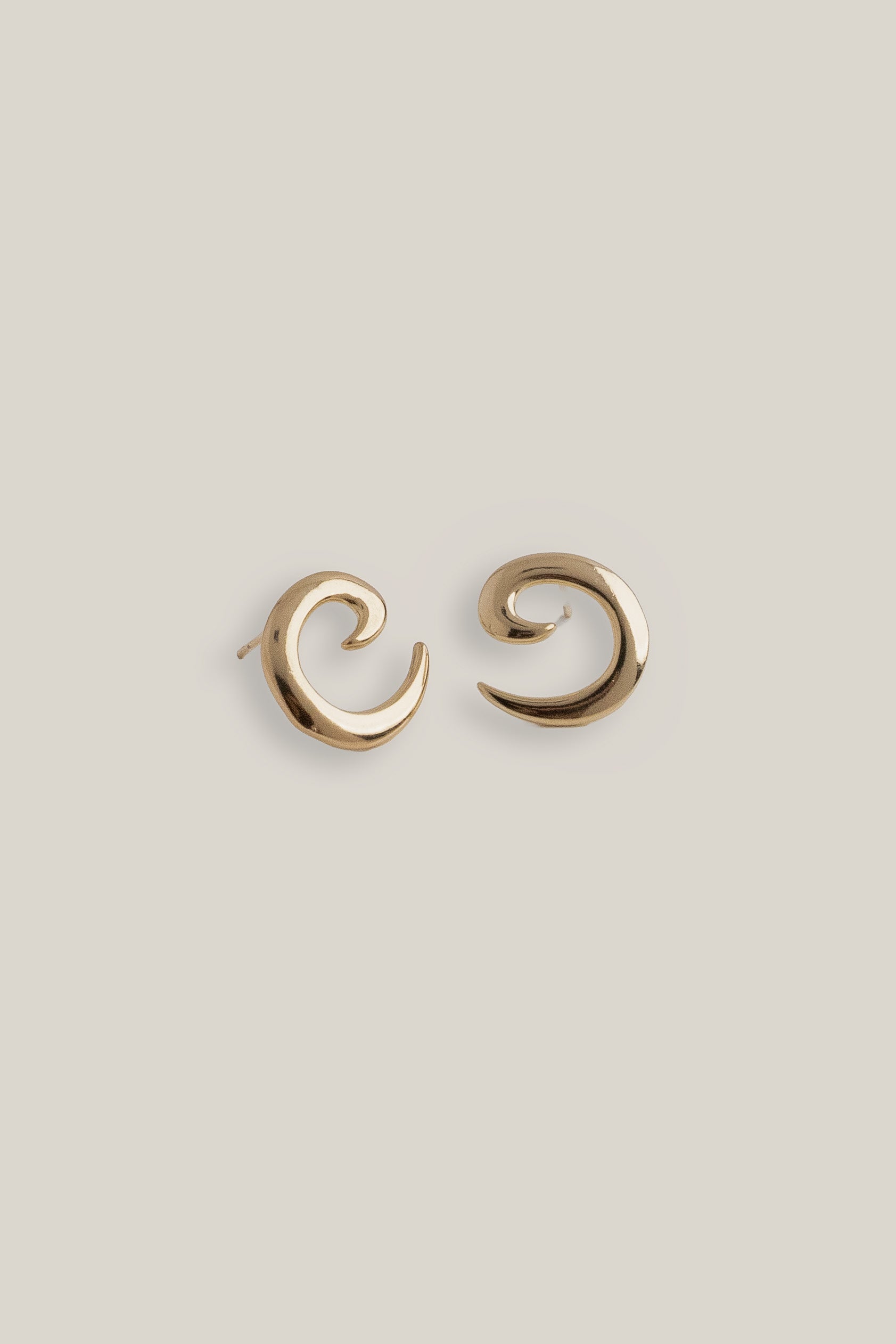 Gold plated spiral earrings with sculptural curved design, shown front facing