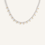 White disc bead necklace with gold drops, styled for a clean summer look.