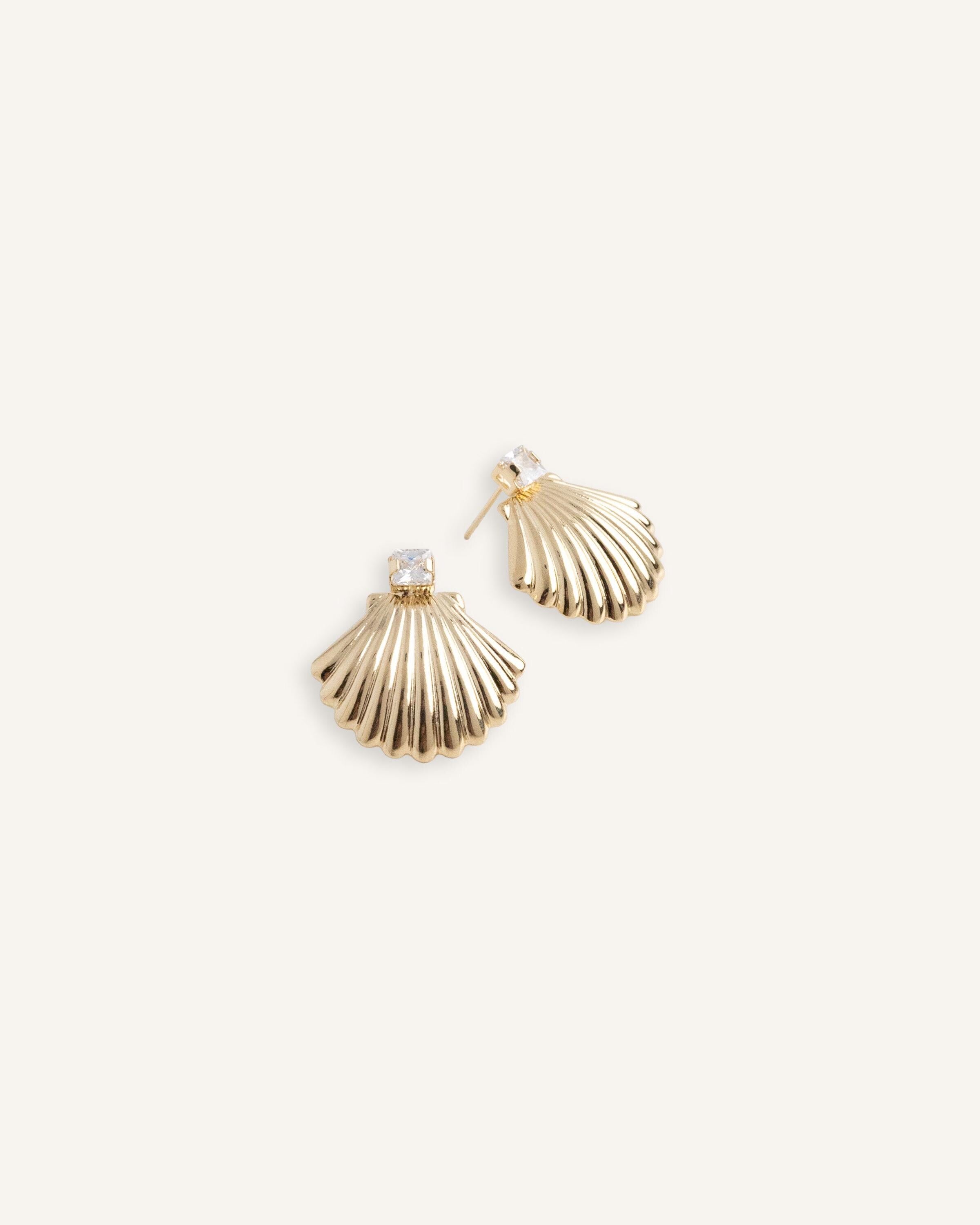 Gold plated shell earrings with square cut crystal tops, shown from front and side angles.