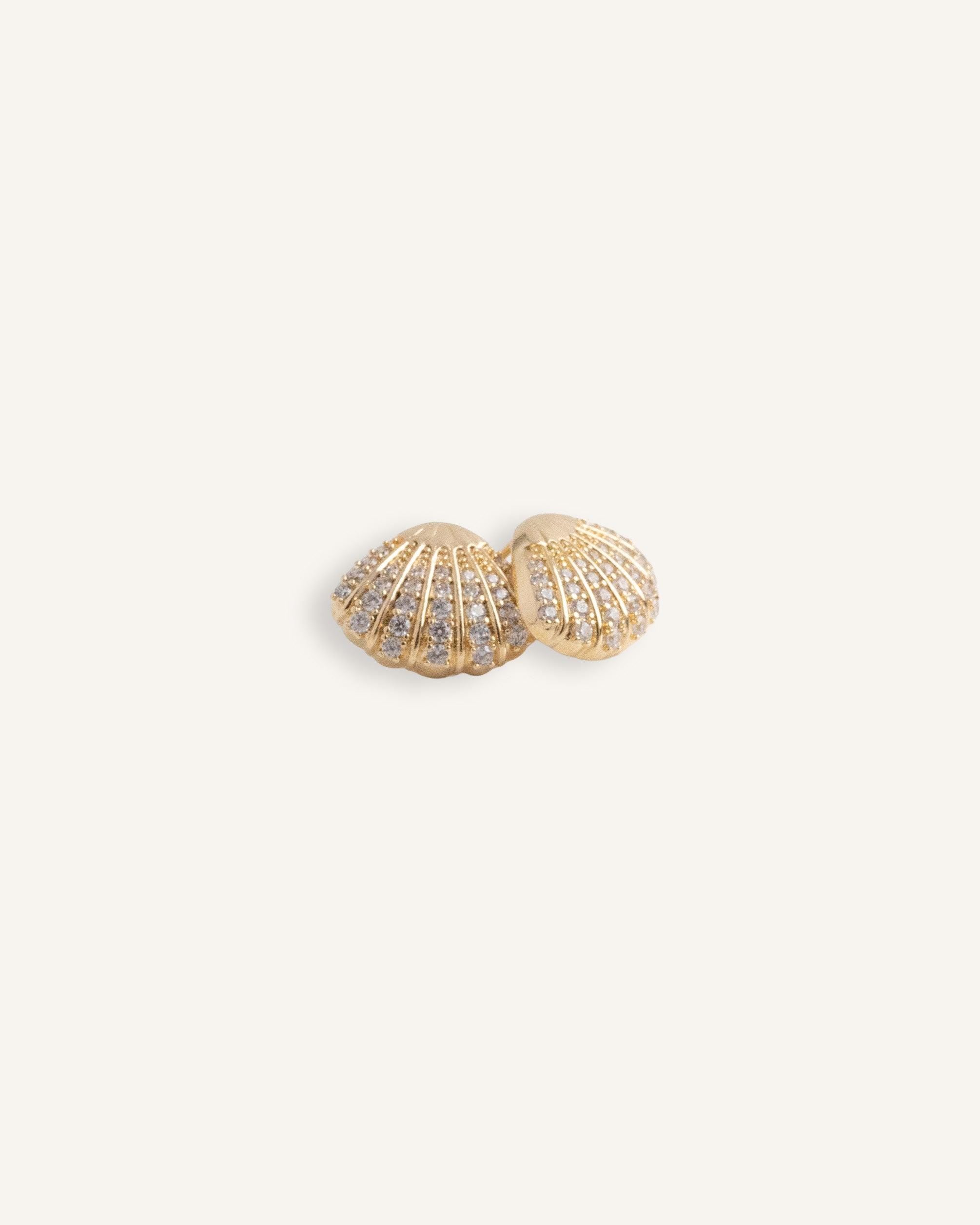 Gold plated shell stud earrings with rows of clear crystals.