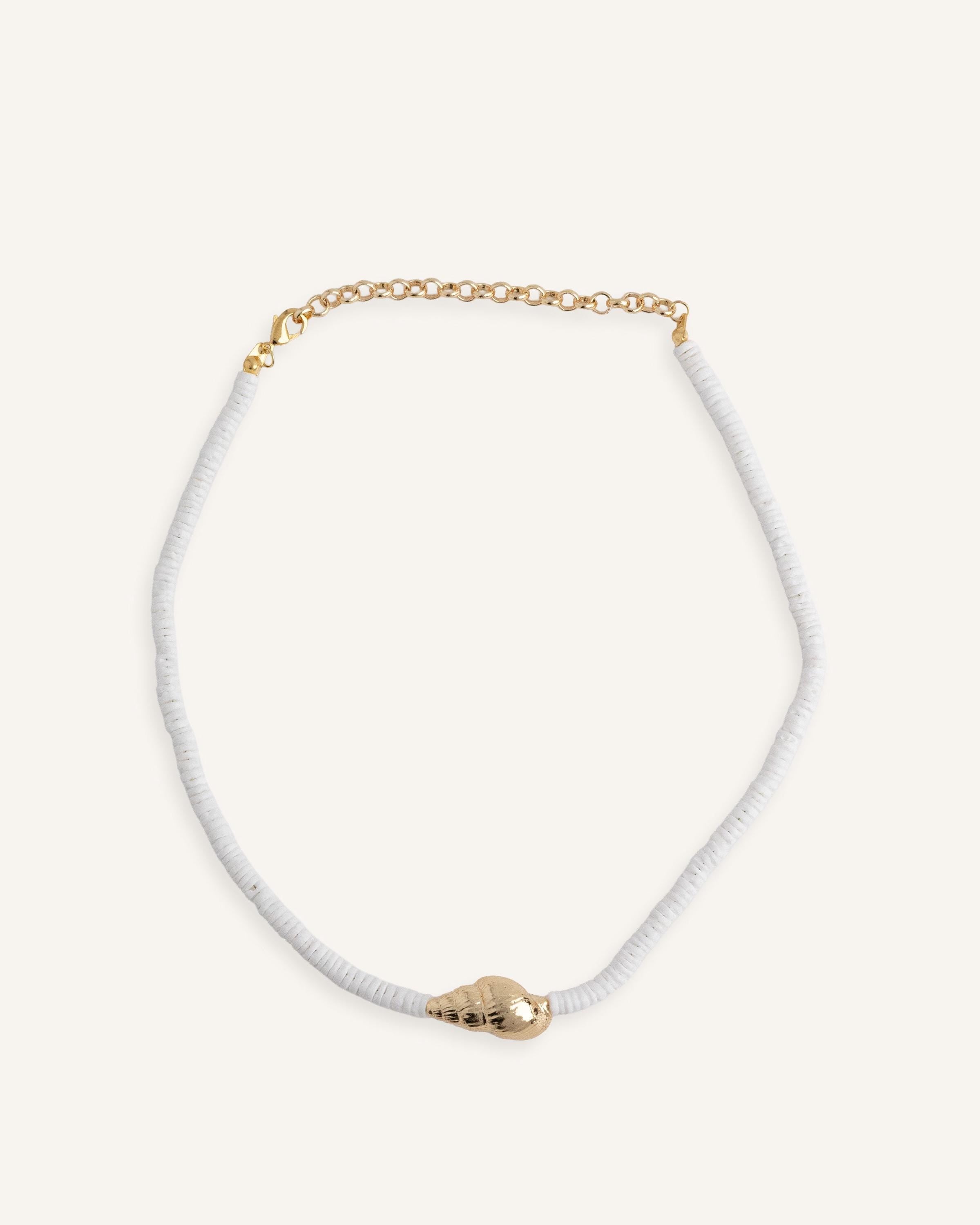 Close-up of gold shell pendant on white beaded choker necklace, ocean-inspired summer jewelry, trendy boho beach accessory for layering