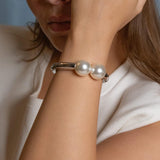 rhodium plated double pearl bracelet with two white pearls, sleek silver-tone minimalist bangle for elegant everyday wear