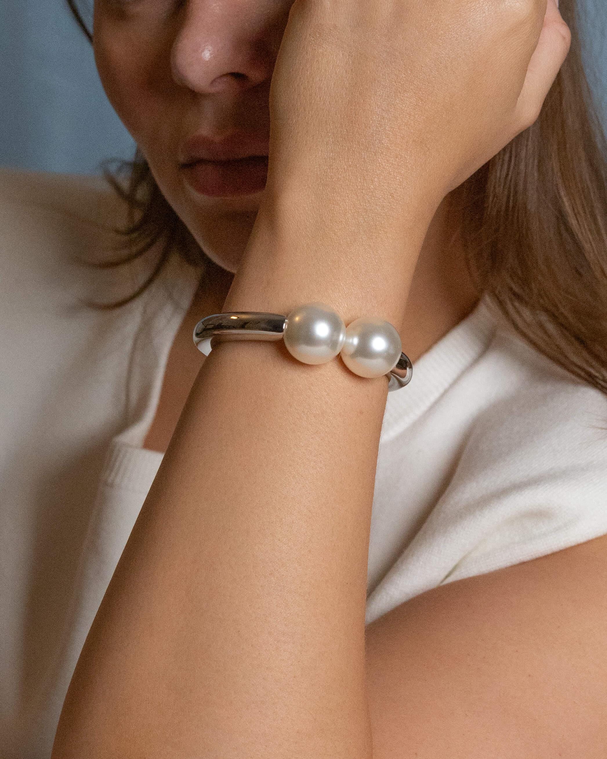 rhodium plated double pearl bracelet with two white pearls, sleek silver-tone minimalist bangle for elegant everyday wear