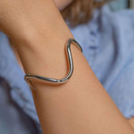 Rhodium plated wavy cuff bracelet with modern sculptural shape, minimalist silver-tone open bangle for women, adjustable contemporary jewelry