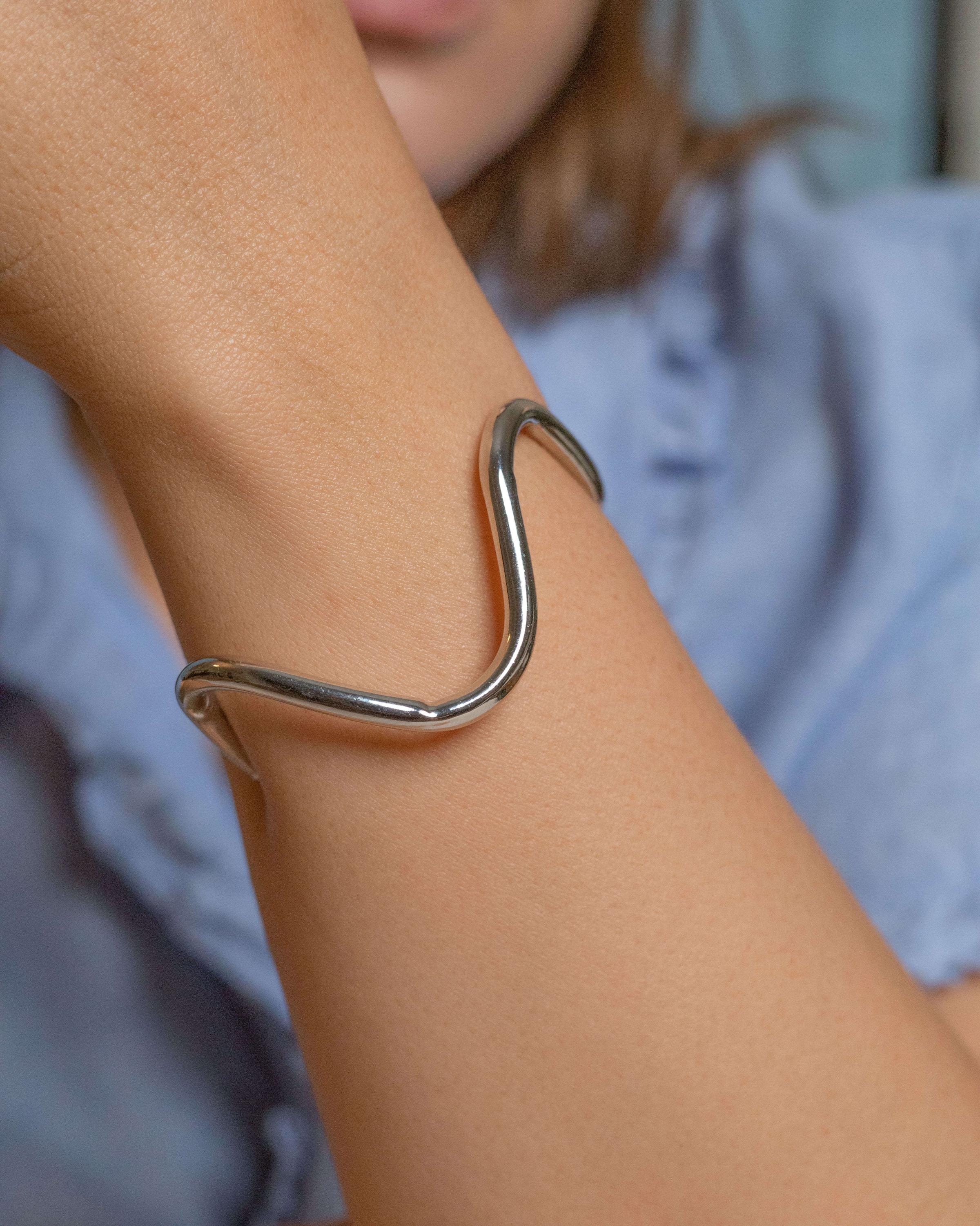 Rhodium plated wavy cuff bracelet with modern sculptural shape, minimalist silver-tone open bangle for women, adjustable contemporary jewelry