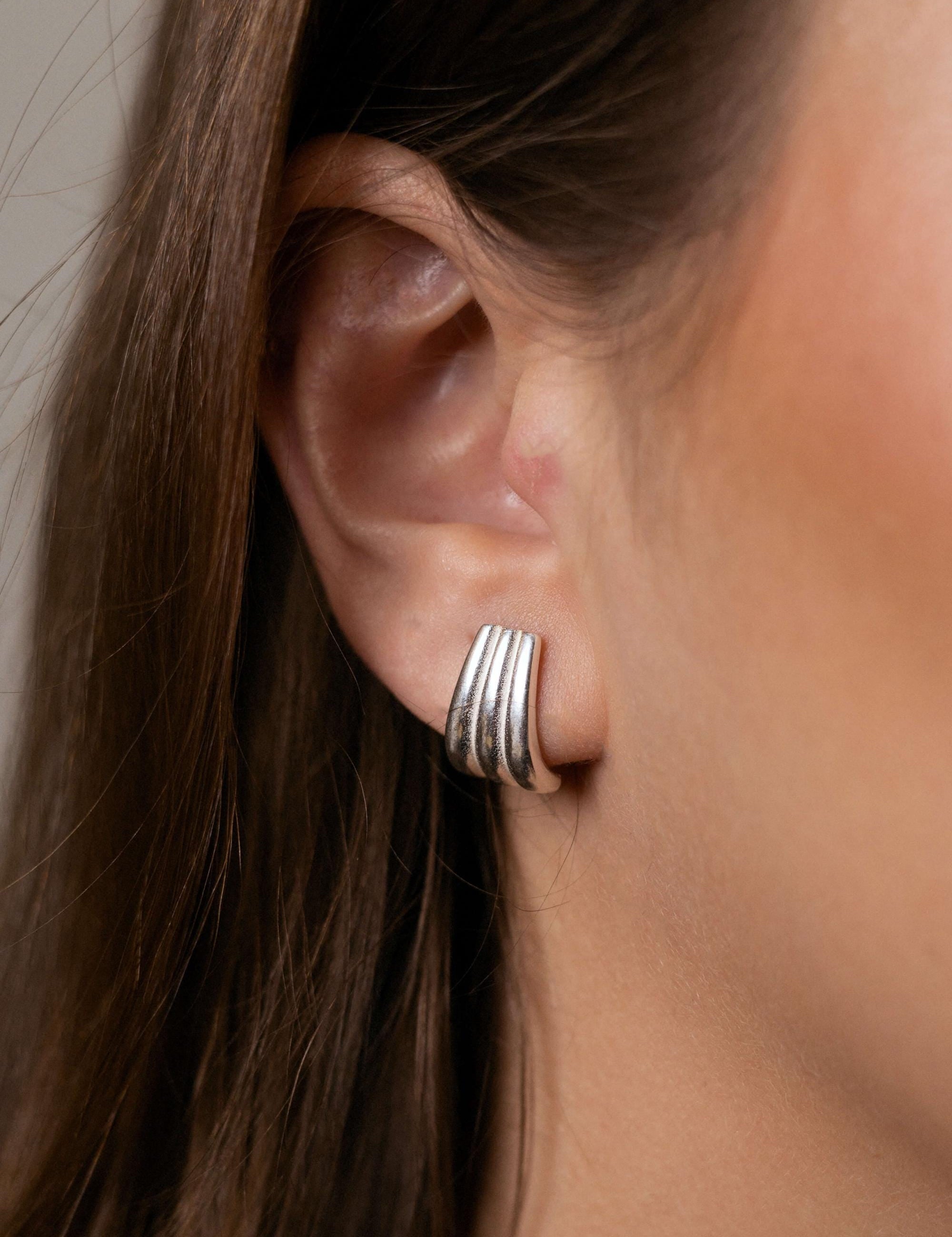 Claire earrings with gold hoop earring set and small dangle earrings, a timeless and chic accessory.