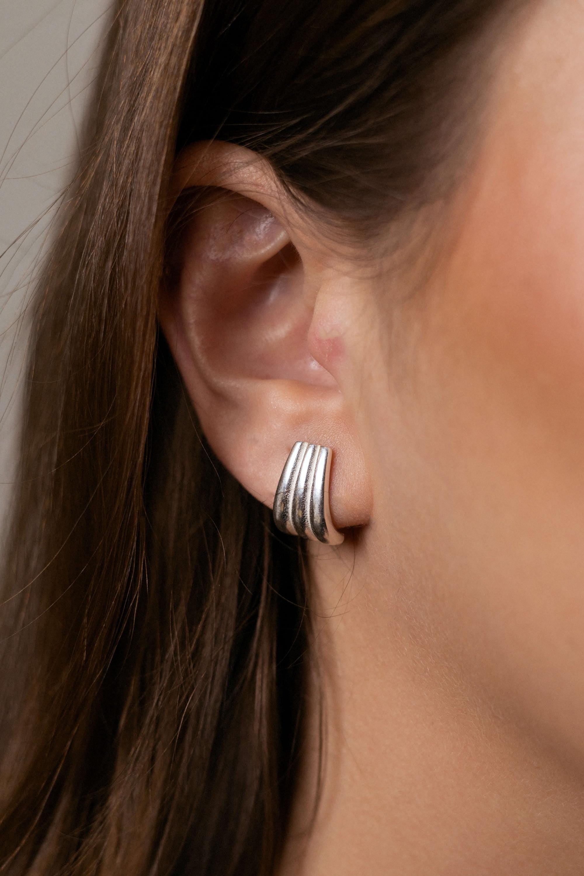 Claire earrings with gold hoop earring set and small dangle earrings, a timeless and chic accessory.