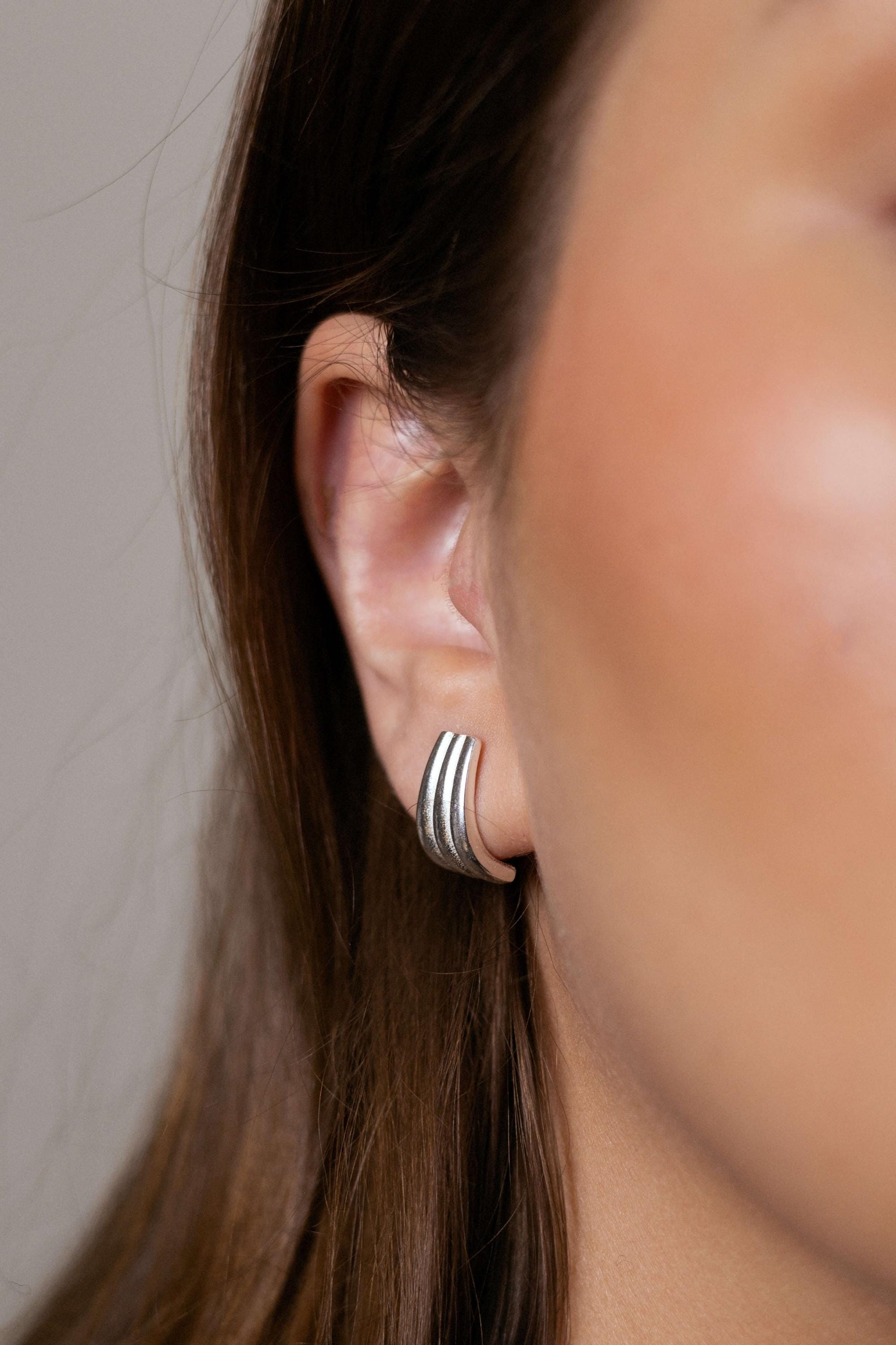 Claire earrings with gold hoop earring set and small dangle earrings, a timeless and chic accessory.