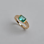 Close up of a jade ring with green gemstone and zircon accents