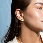 Close-up of 14k gold plated seashell stud earrings, elegant beach-style jewelry for women, casual summer earrings gift idea