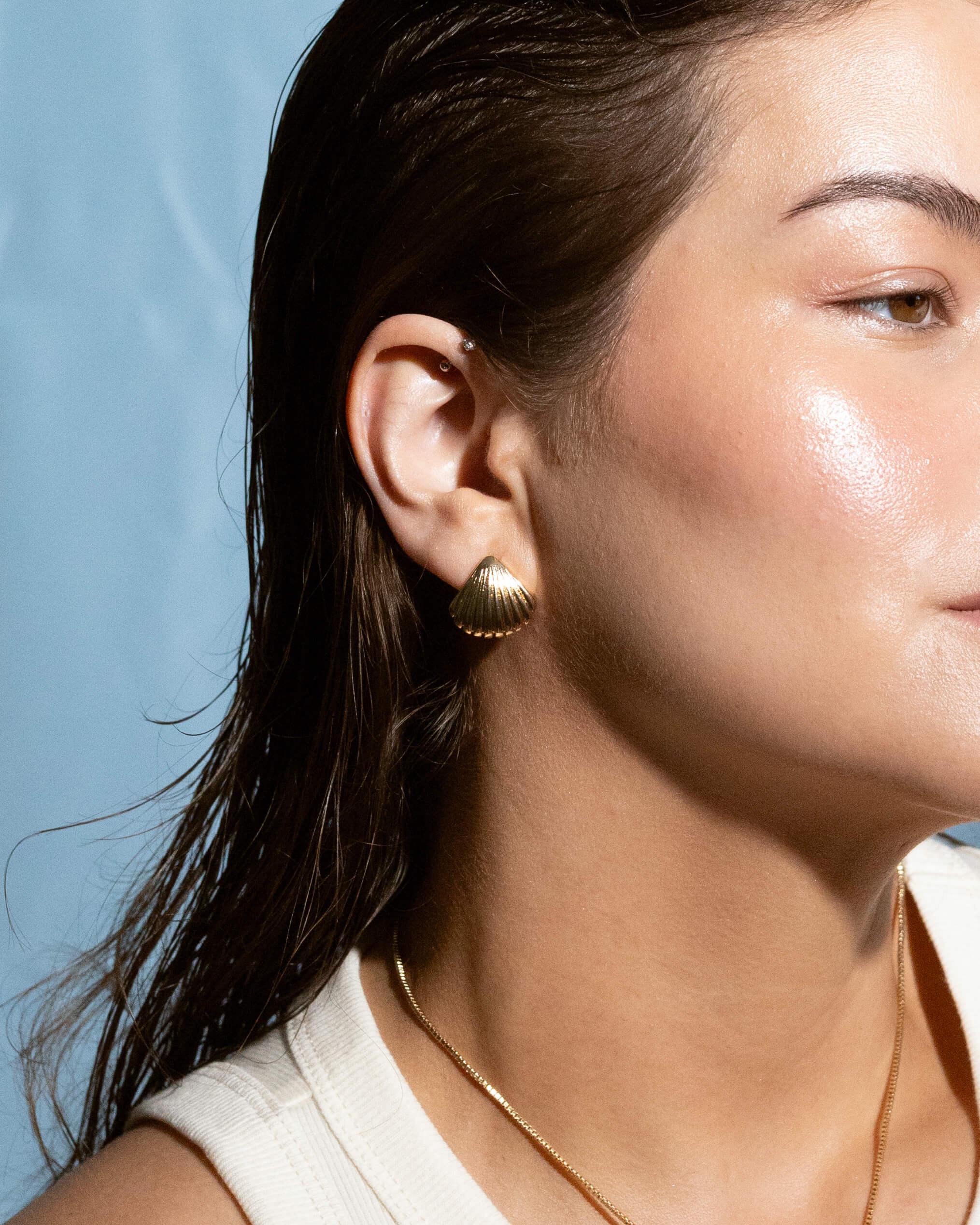 Close-up of 14k gold plated seashell stud earrings, elegant beach-style jewelry for women, casual summer earrings gift idea