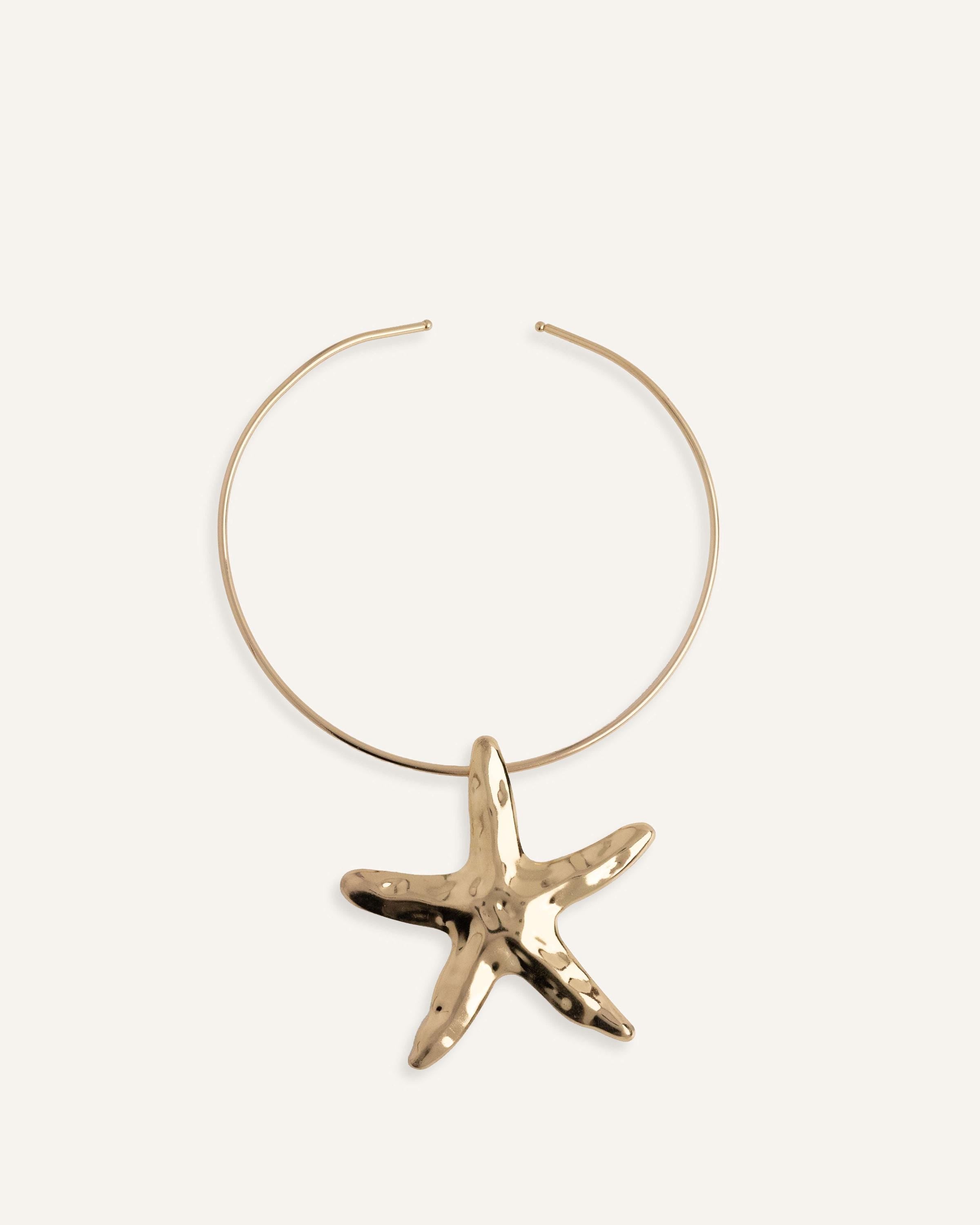 Structured gold choker necklace with large starfish pendant.