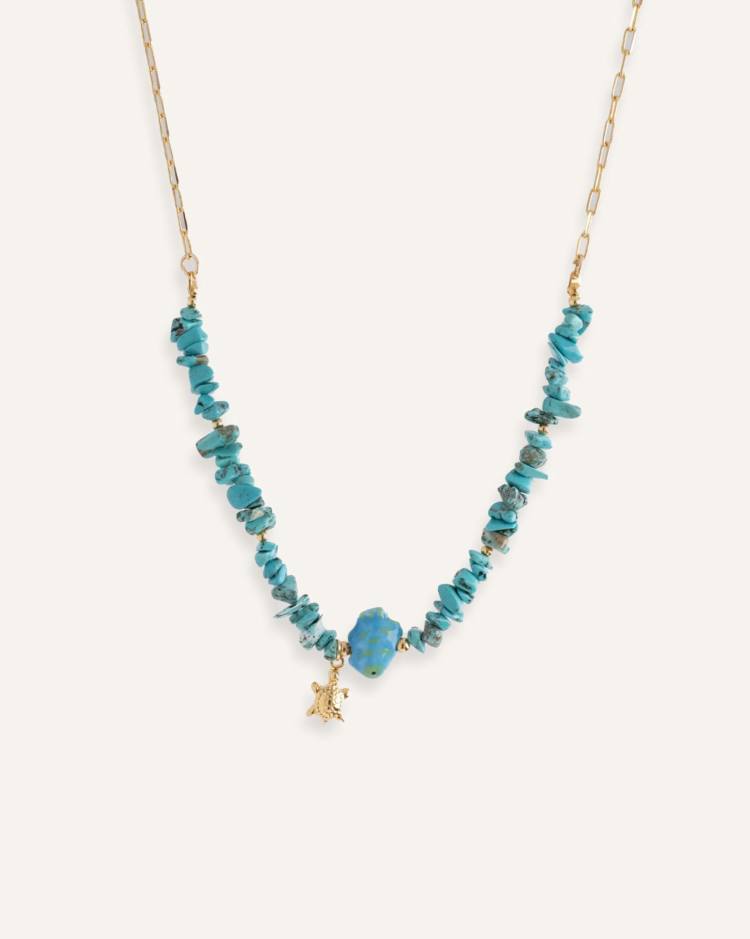 Turquoise chip necklaces with colorful ceramic fish beads and small gold star charms, in orange and blue variations.
