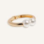 Hinged cuff bracelet with two pearl accents, shown in gold-plated and silver finishes