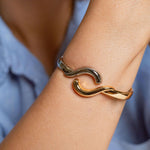 Two-tone wave bangle bracelet in gold-plated and rhodium finish with hinge closure – ocean-inspired cuff
