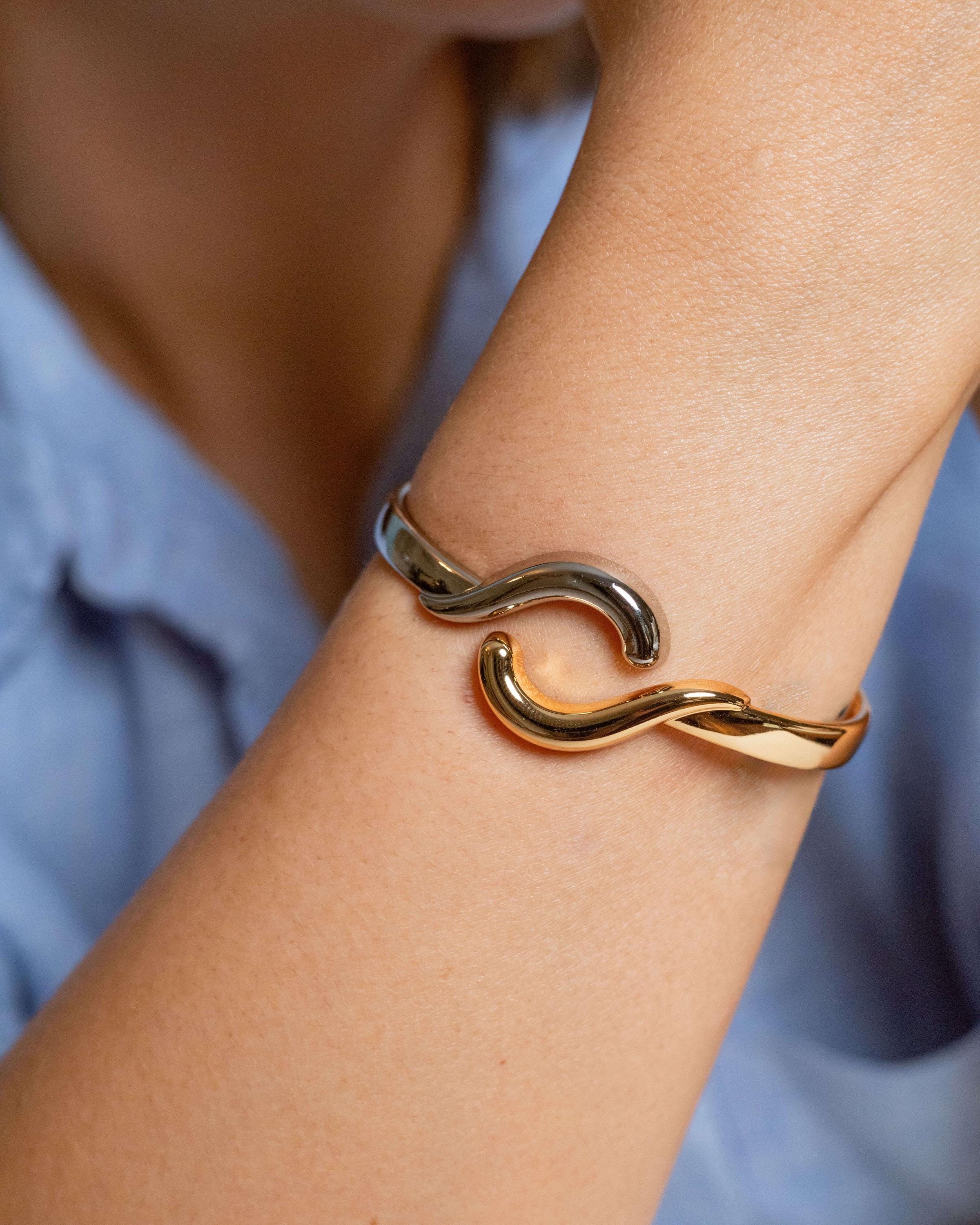 Two-tone wave bangle bracelet in gold-plated and rhodium finish with hinge closure – ocean-inspired cuff