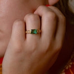 Elegant jade ring featuring a vibrant green stone and three zircon details