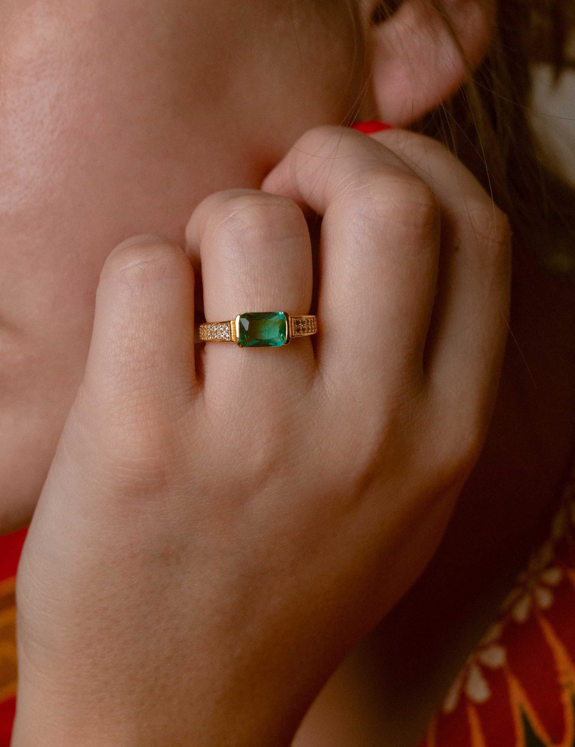 Elegant jade ring featuring a vibrant green stone and three zircon details
