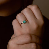 Close-up of handcrafted stone ring with turquoise detail