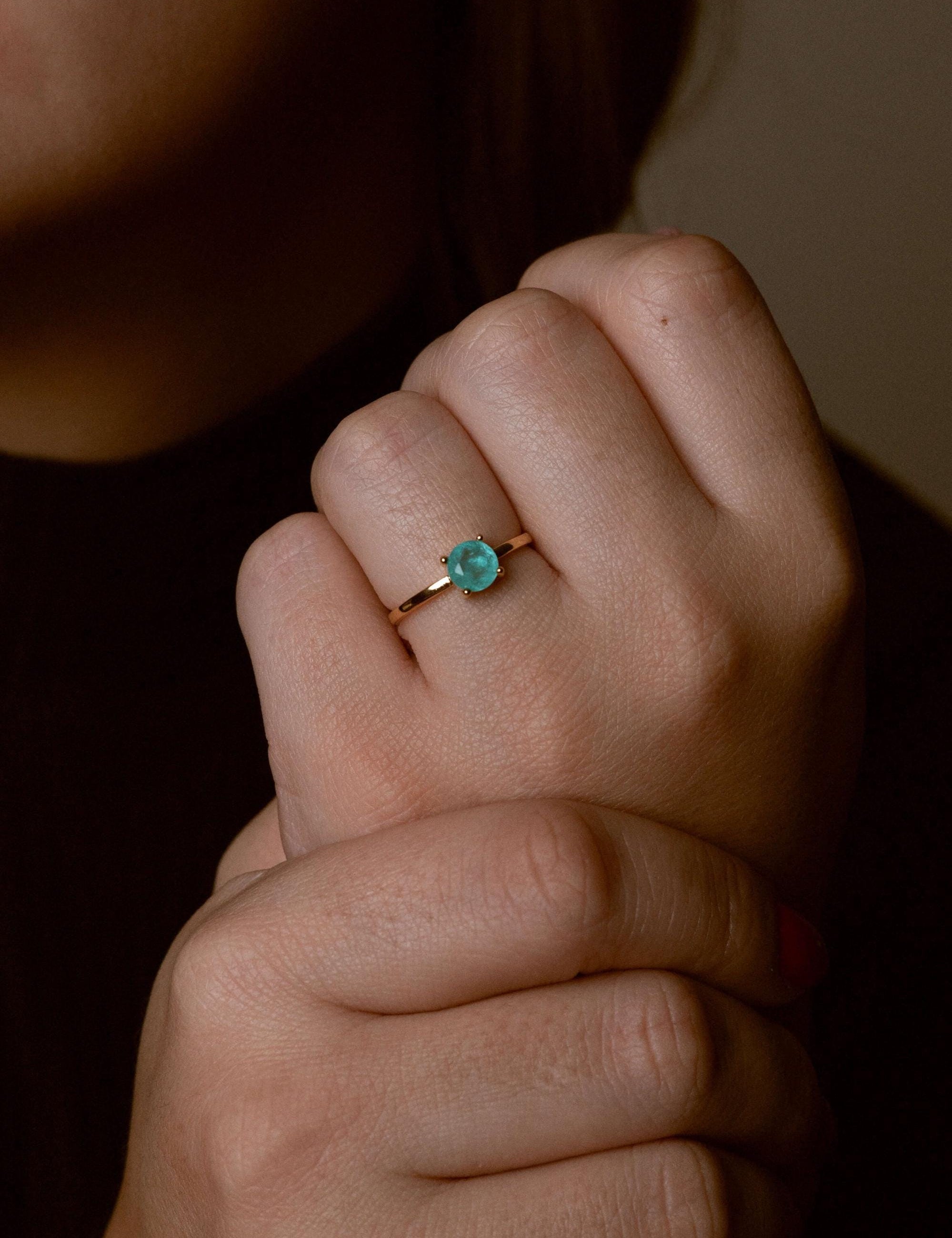 Close-up of handcrafted stone ring with turquoise detail
