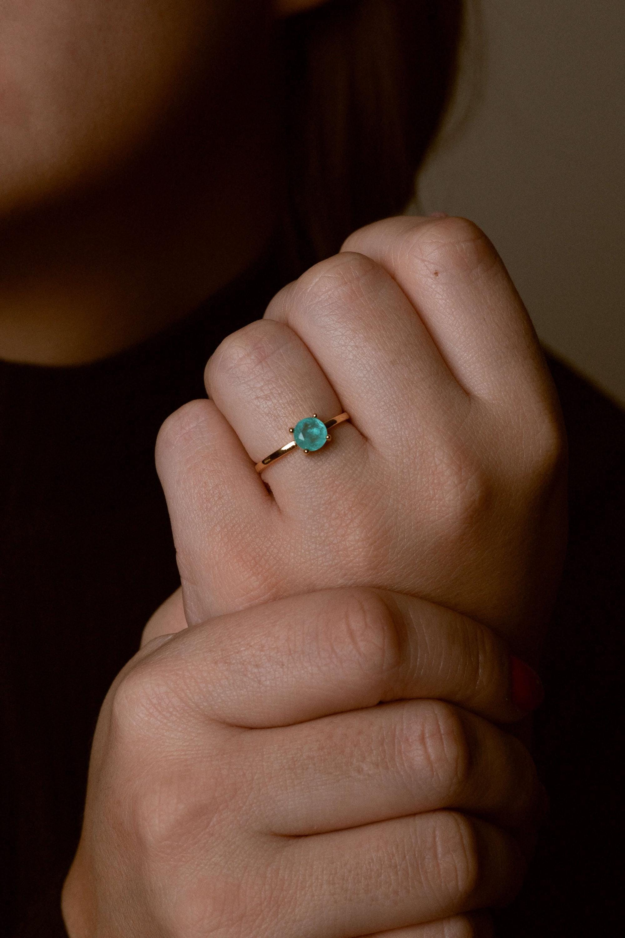 Close-up of handcrafted stone ring with turquoise detail