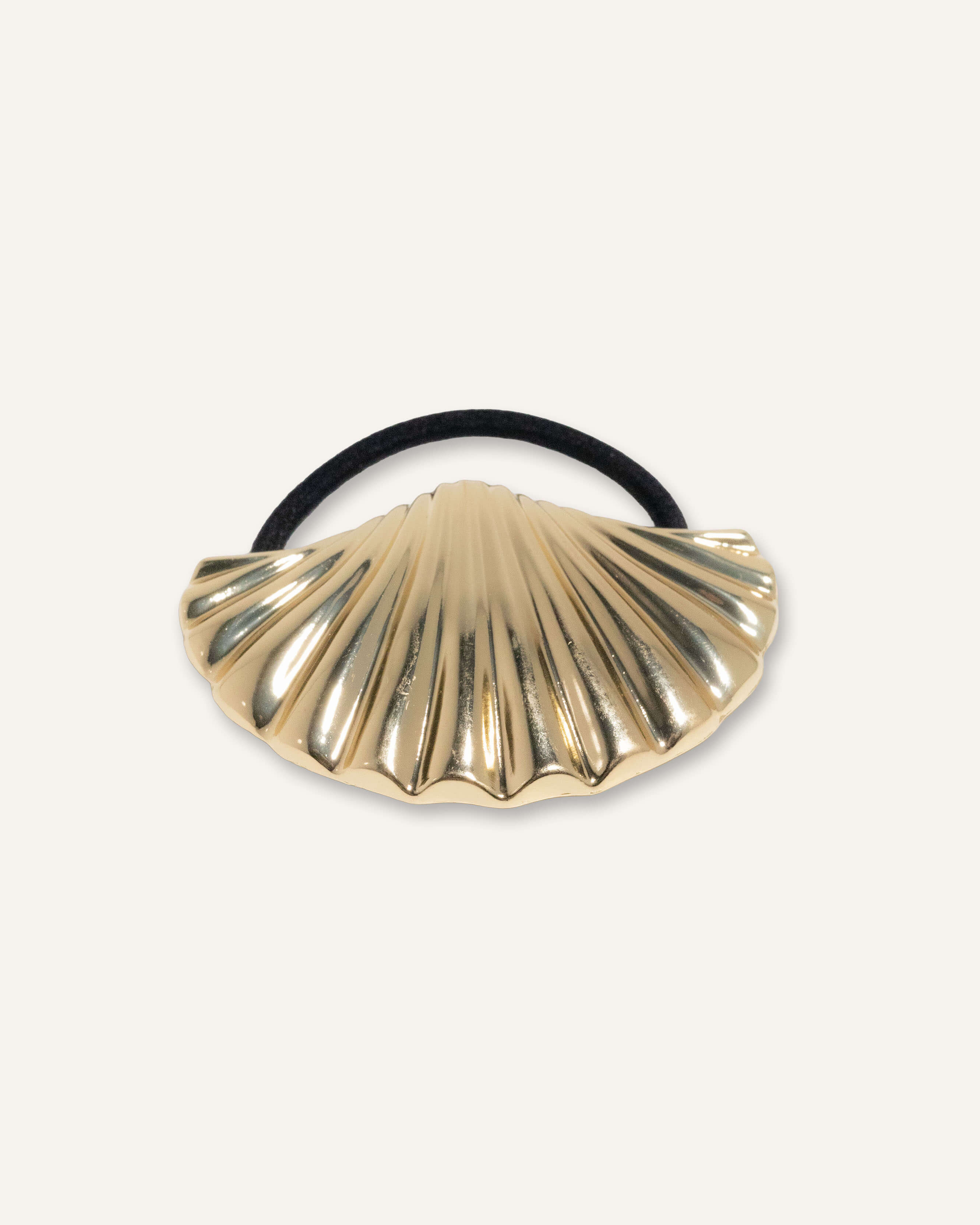 Gold and silver scallop shell hair ties with black elastic bands.
