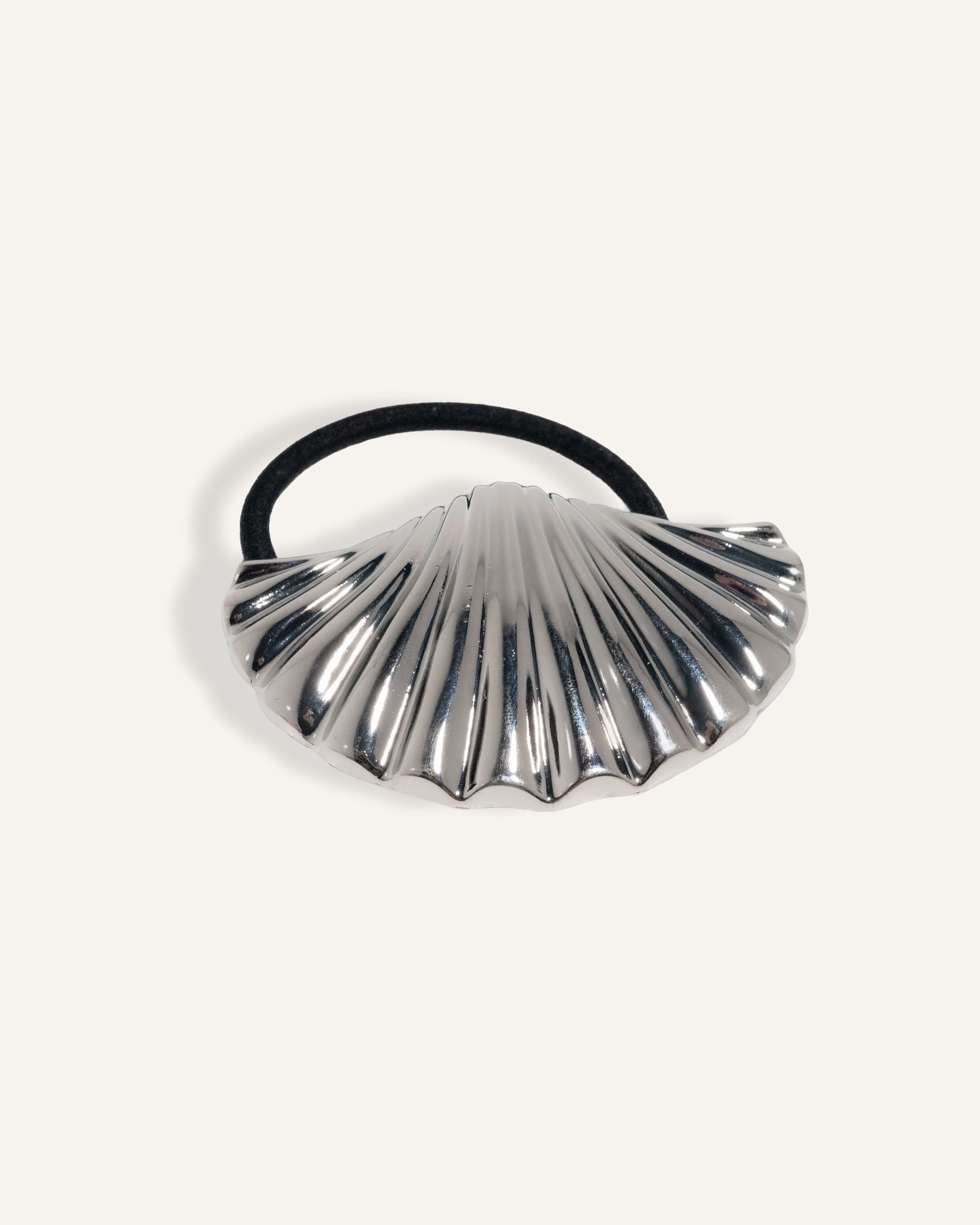 Gold and silver scallop shell hair ties with black elastic bands.
