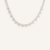  White disc bead necklace with gold drops, styled for a clean summer look.