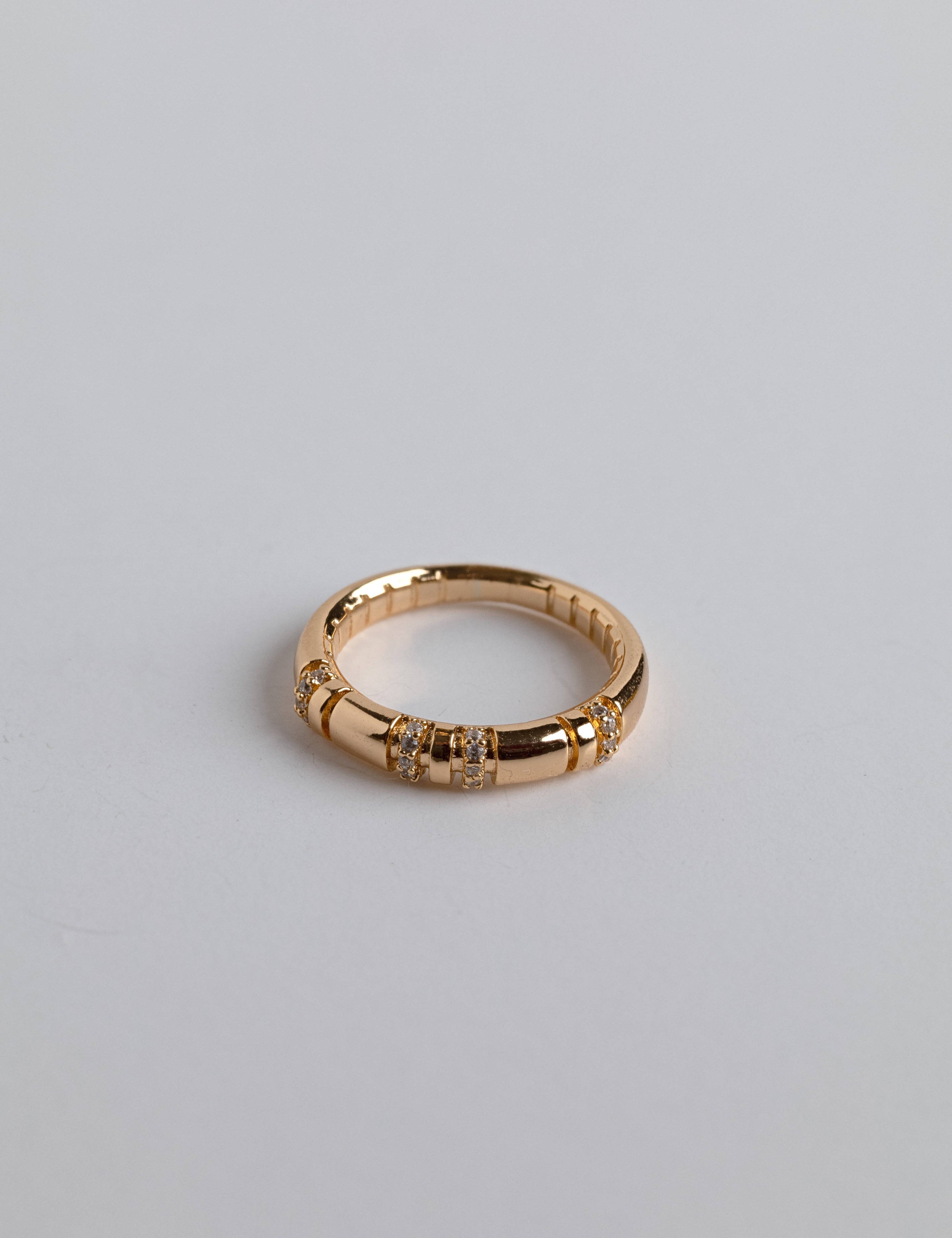 Close-up of 14K gold plated metal ring featuring a zircon accent