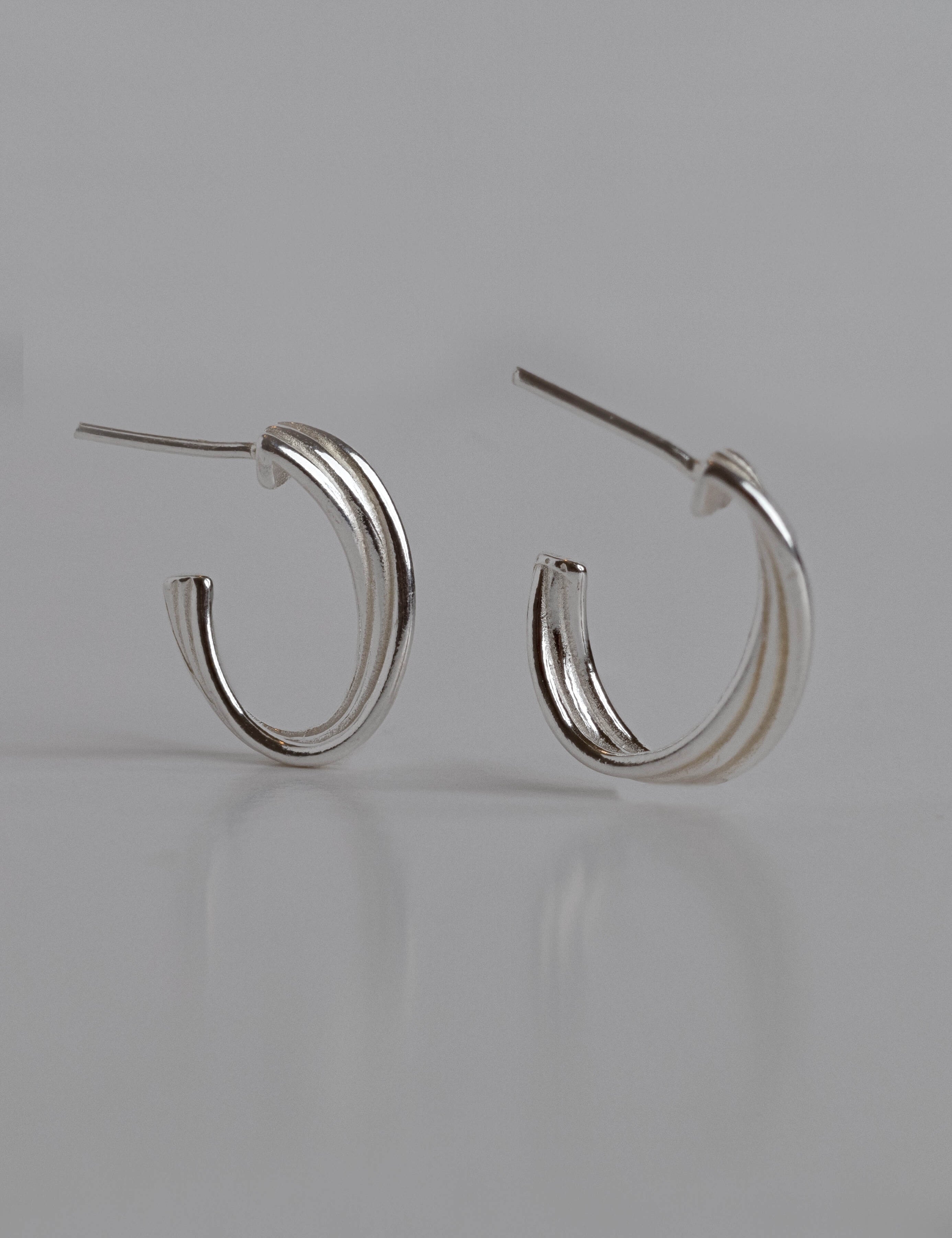 Betina earrings with gold hoop earring set and small dangle earrings, a timeless and chic accessory.