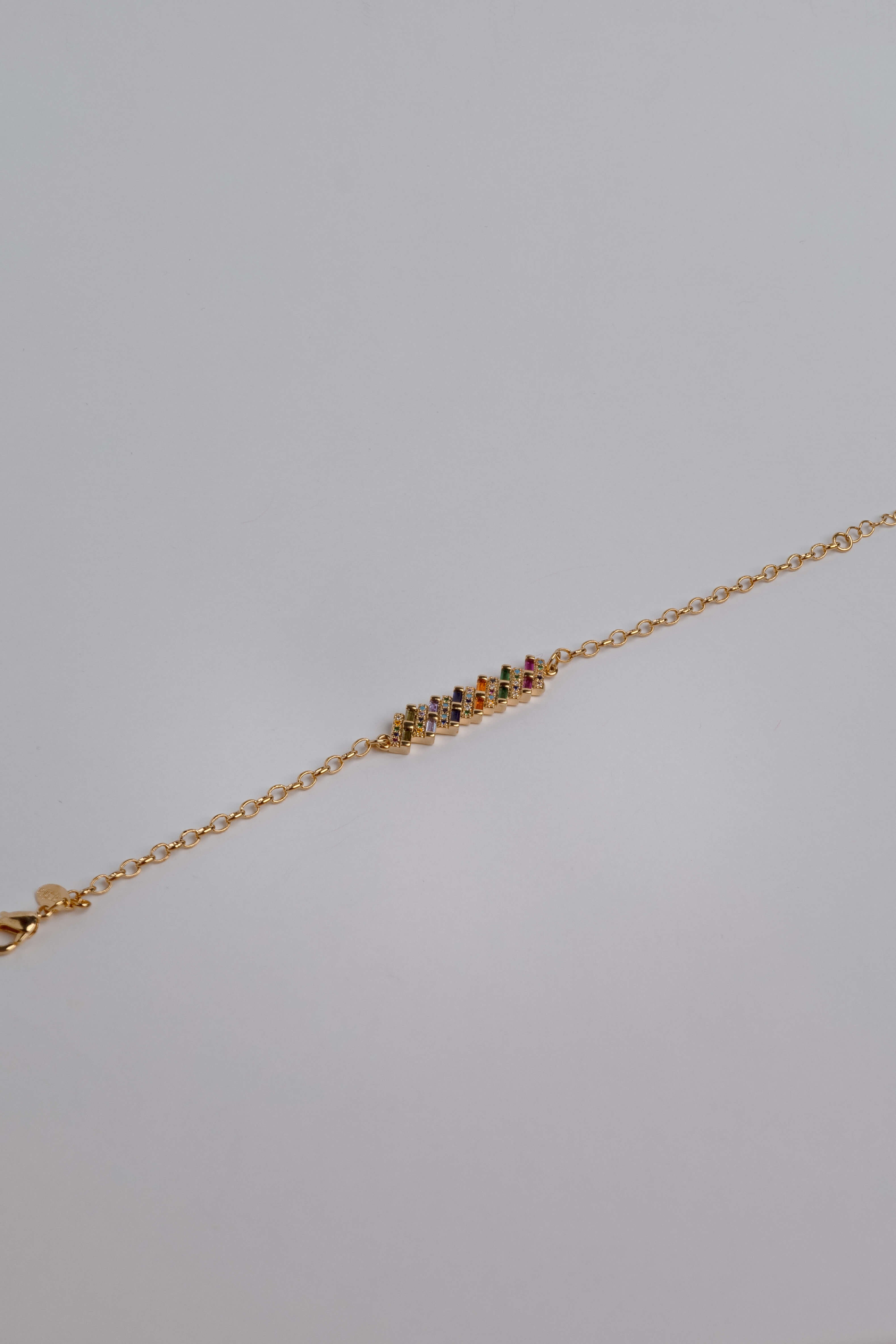 Slim gold-dipped bracelet with colored crystals, designed for a delicate and refined look.