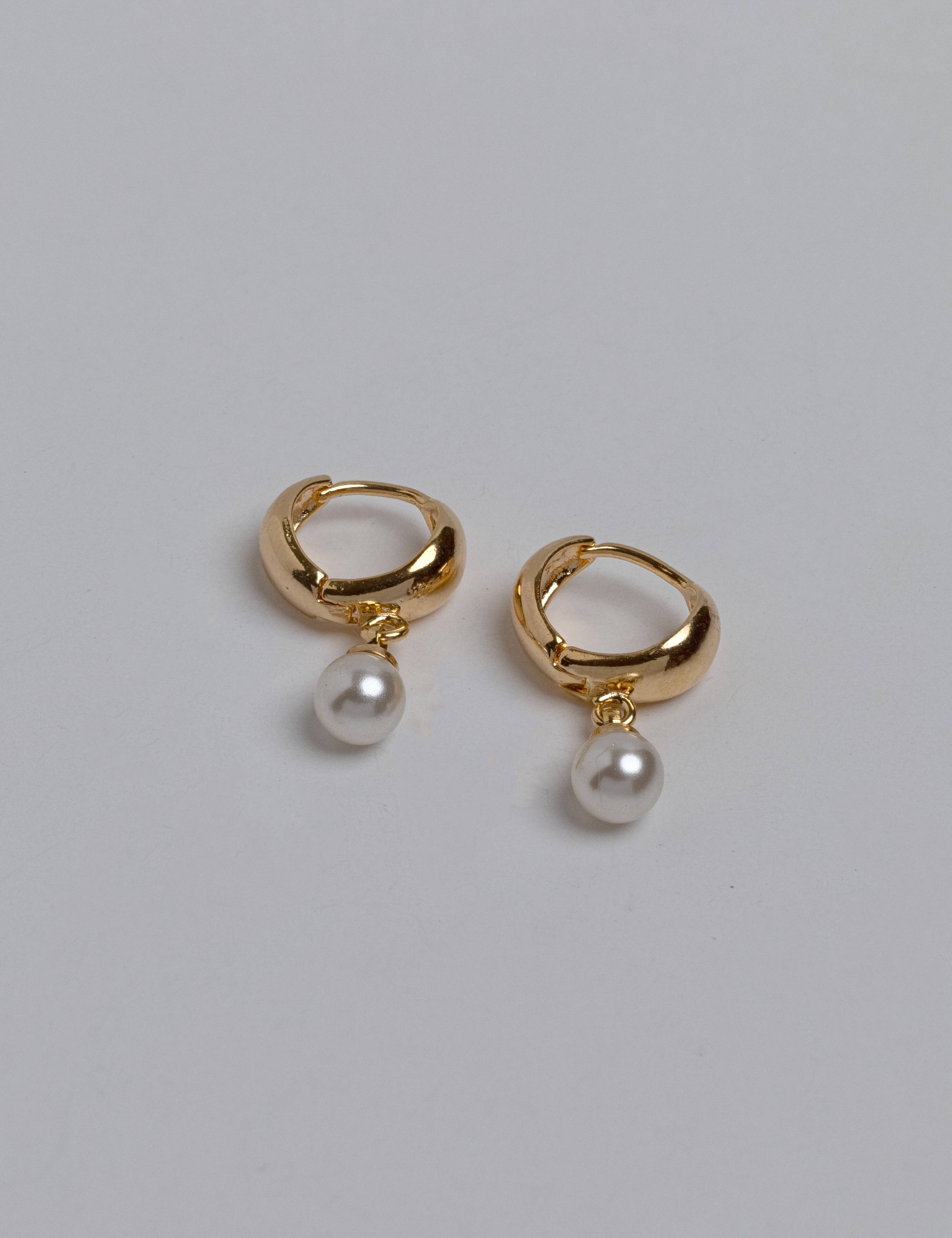 Bella earrings with gold hoop earring set and small dangle earrings, a timeless and chic accessory.