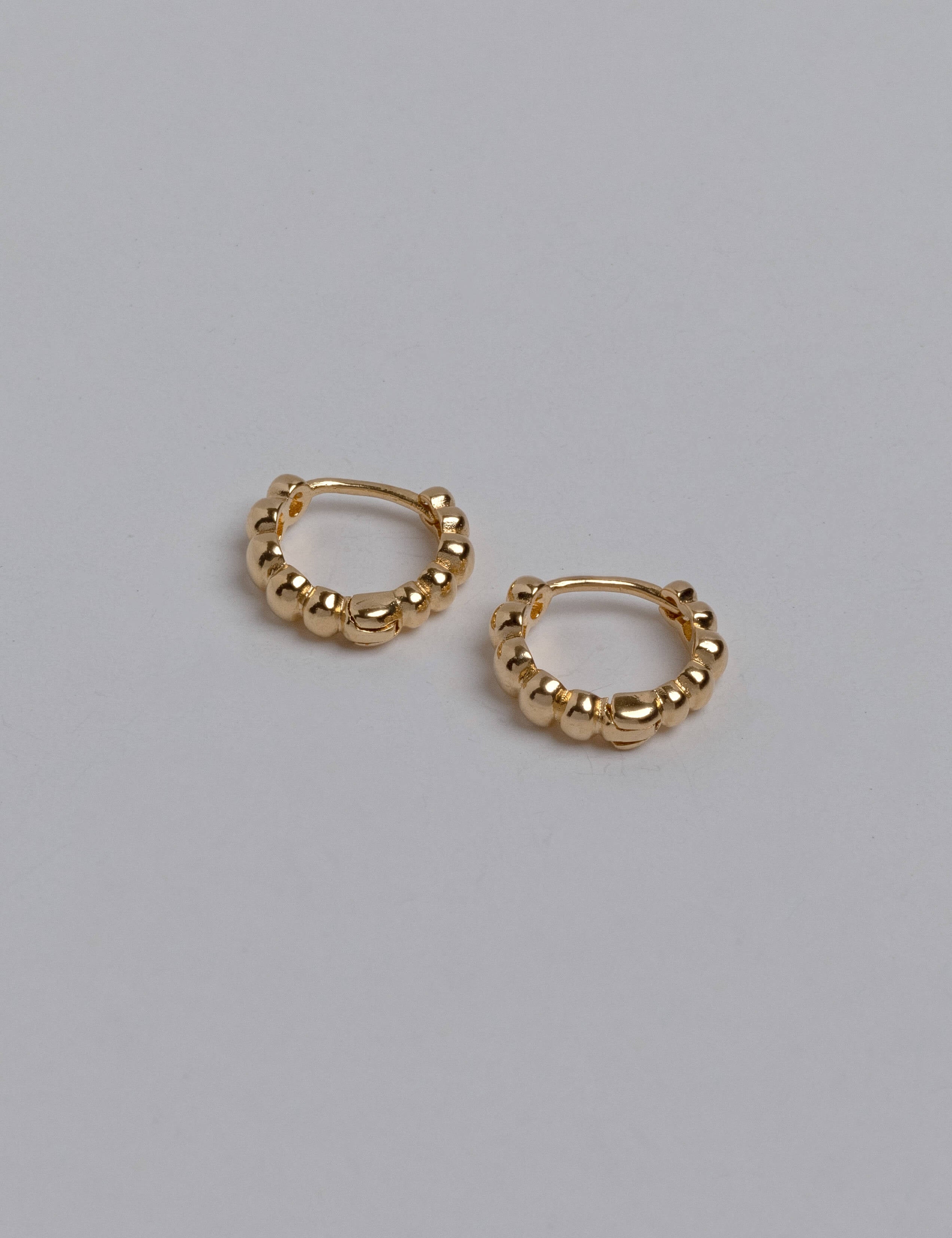 Brianna earrings with gold hoop earring set and small dangle earrings, a timeless and chic accessory.