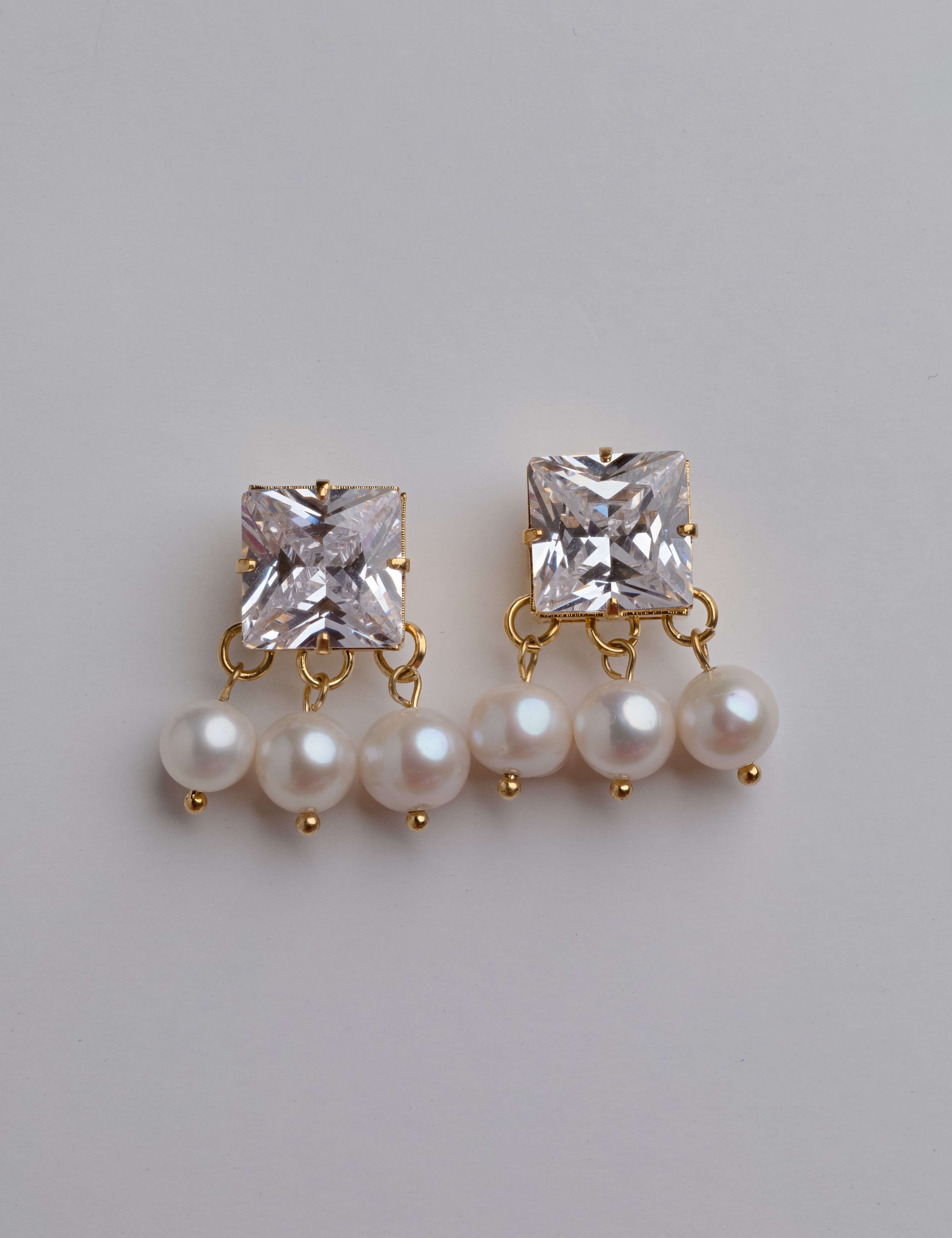 Lydia earrings with gold hoop earring set and small dangle earrings, a timeless and chic accessory.