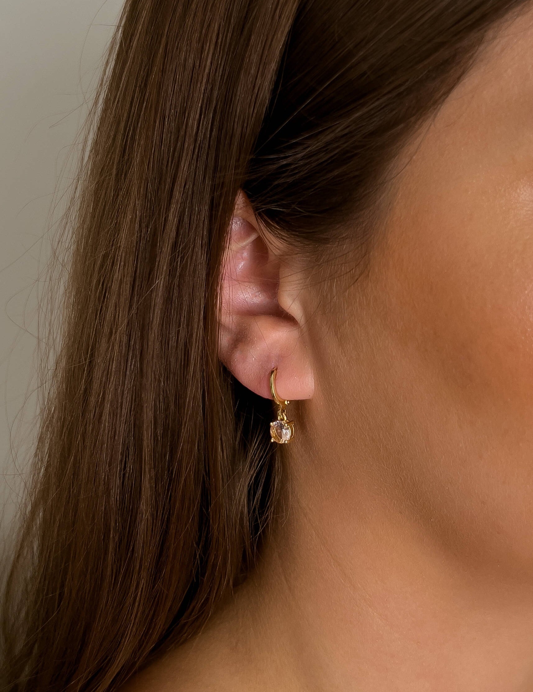 Lia earrings with gold hoop earring set and small dangle earrings, a timeless and chic accessory.