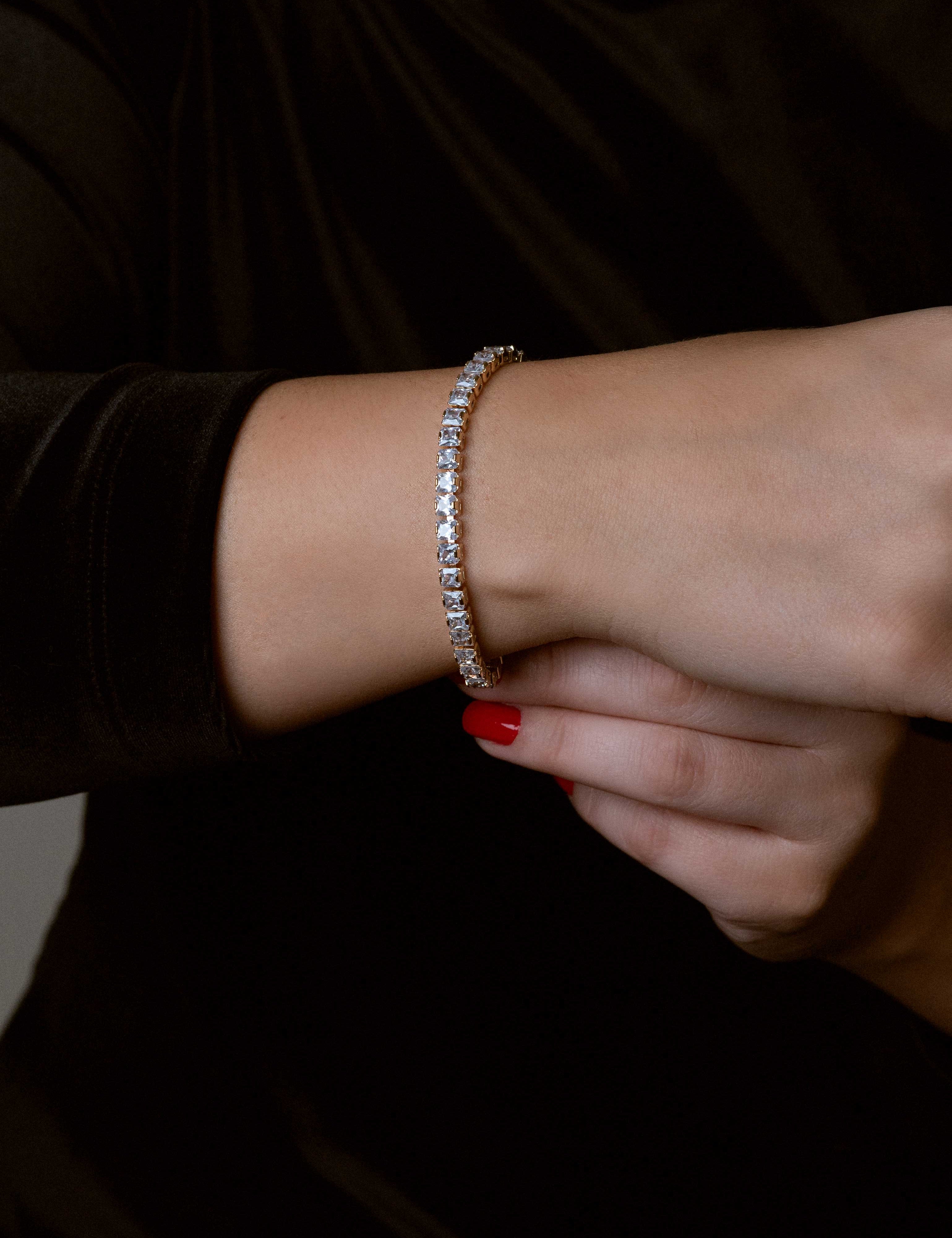 Square gold-dipped women's tennis bracelet with cubic zirconia stones, featuring a structured and refined design.