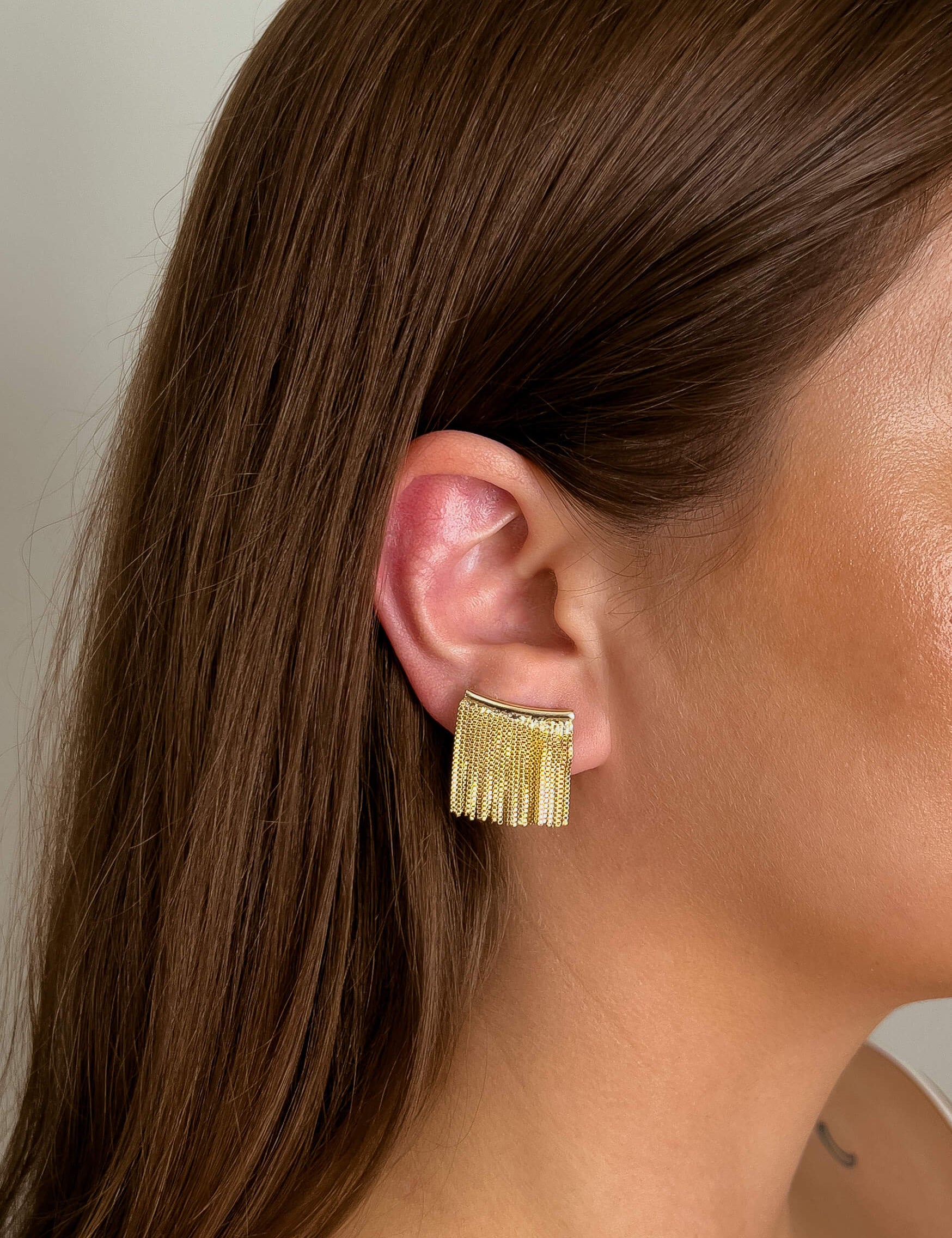 Leona earrings with gold hoop earring set and small dangle earrings, a timeless and chic accessory.