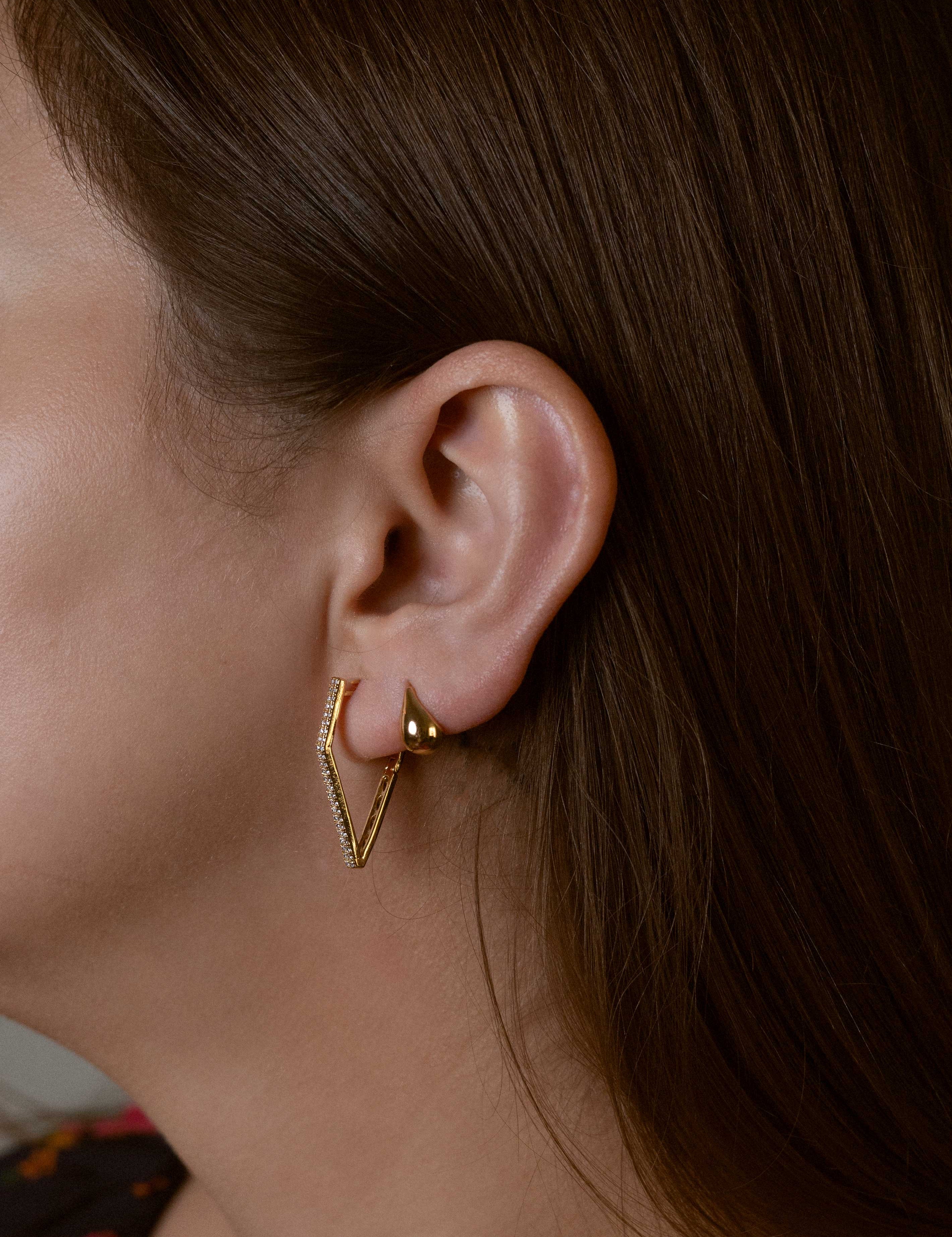 Gabriela earrings with gold hoop earring set and small dangle earrings, a timeless and chic accessory.