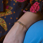 Slim gold-dipped bracelet with colored crystals, designed for a delicate and refined look.
