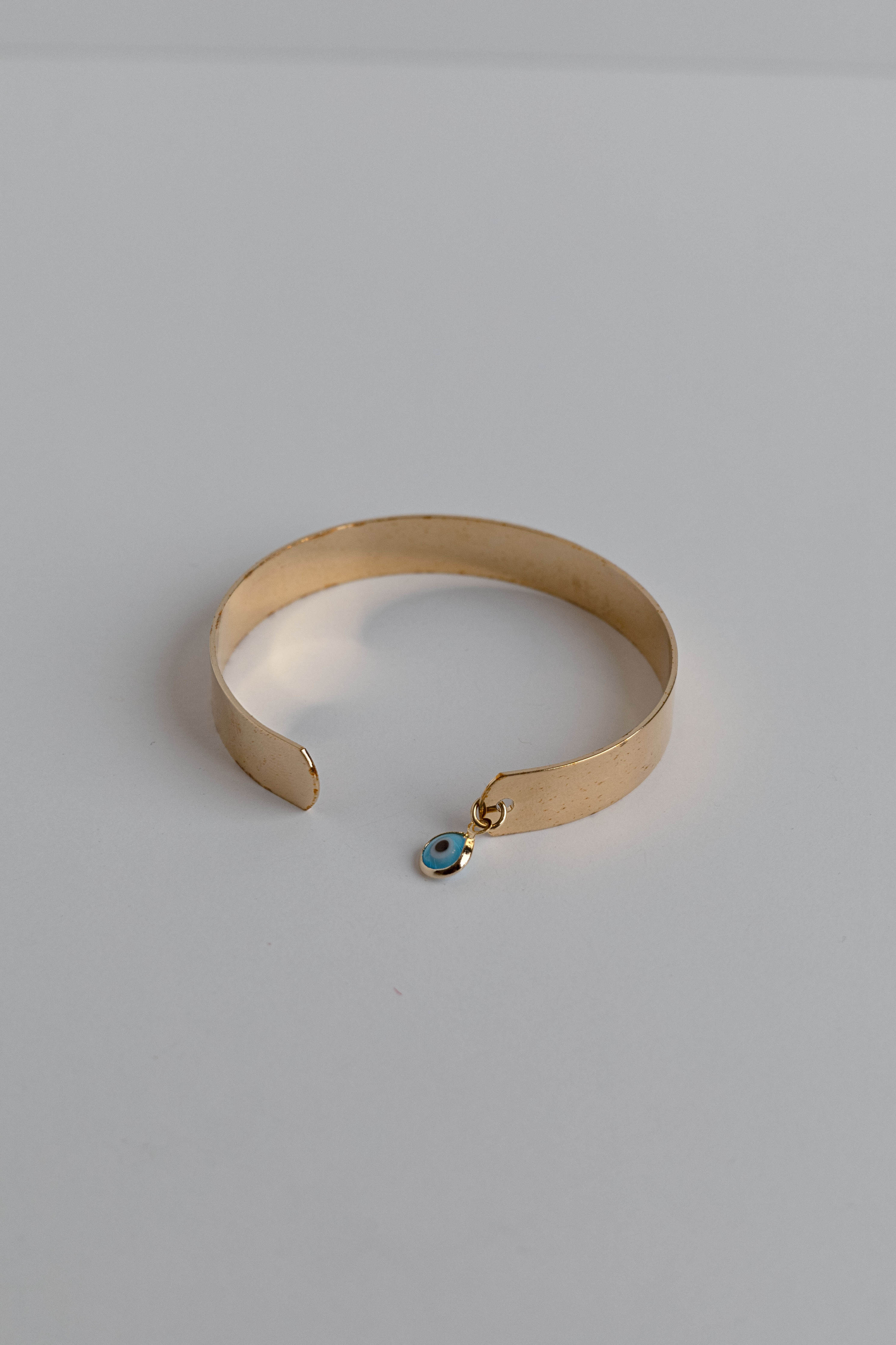 Gold-dipped evil eye bracelet with a protective design, crafted for everyday wear.