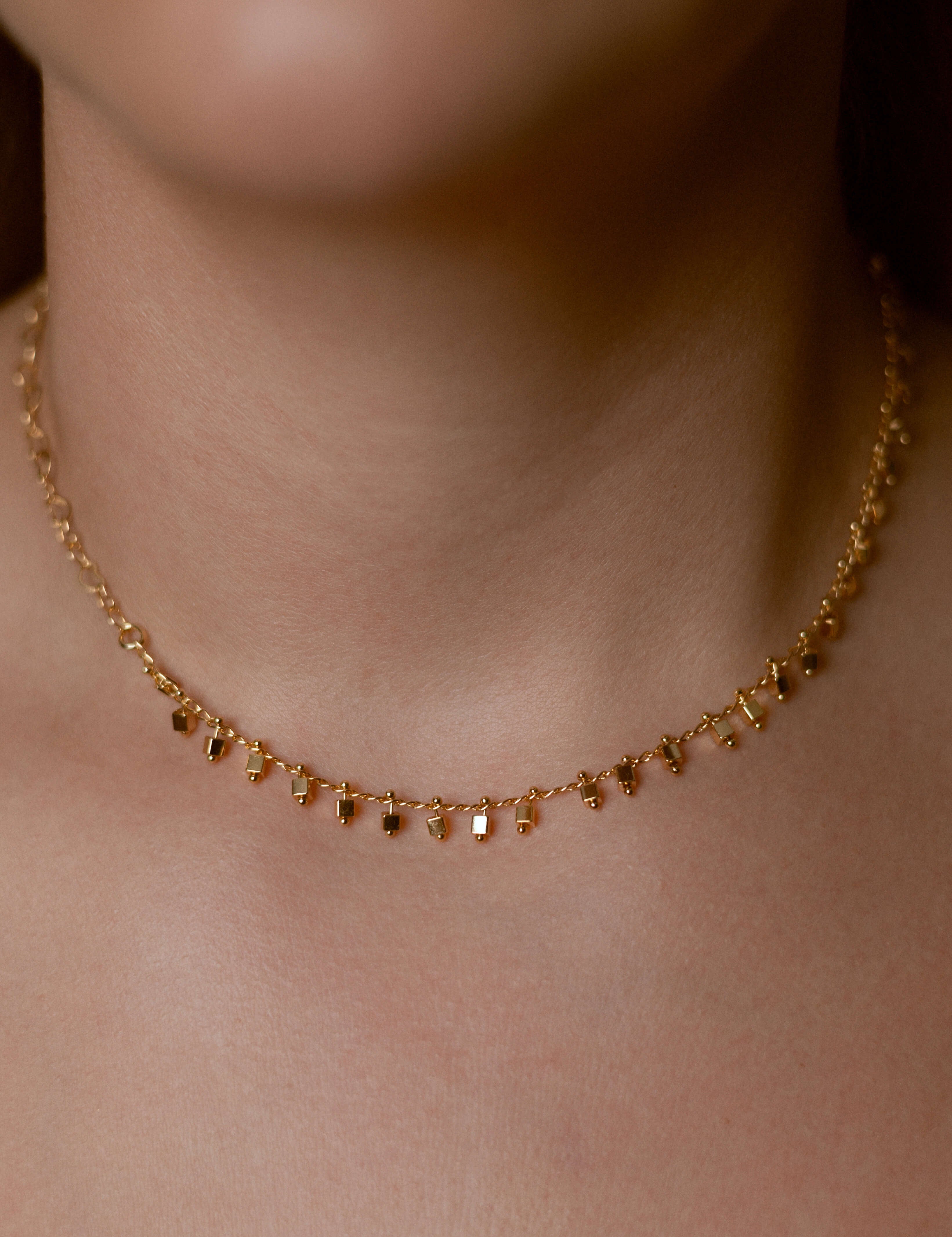 Delicate gold necklace with a minimalist square pendant, 18K gold plated, lightweight and stylish