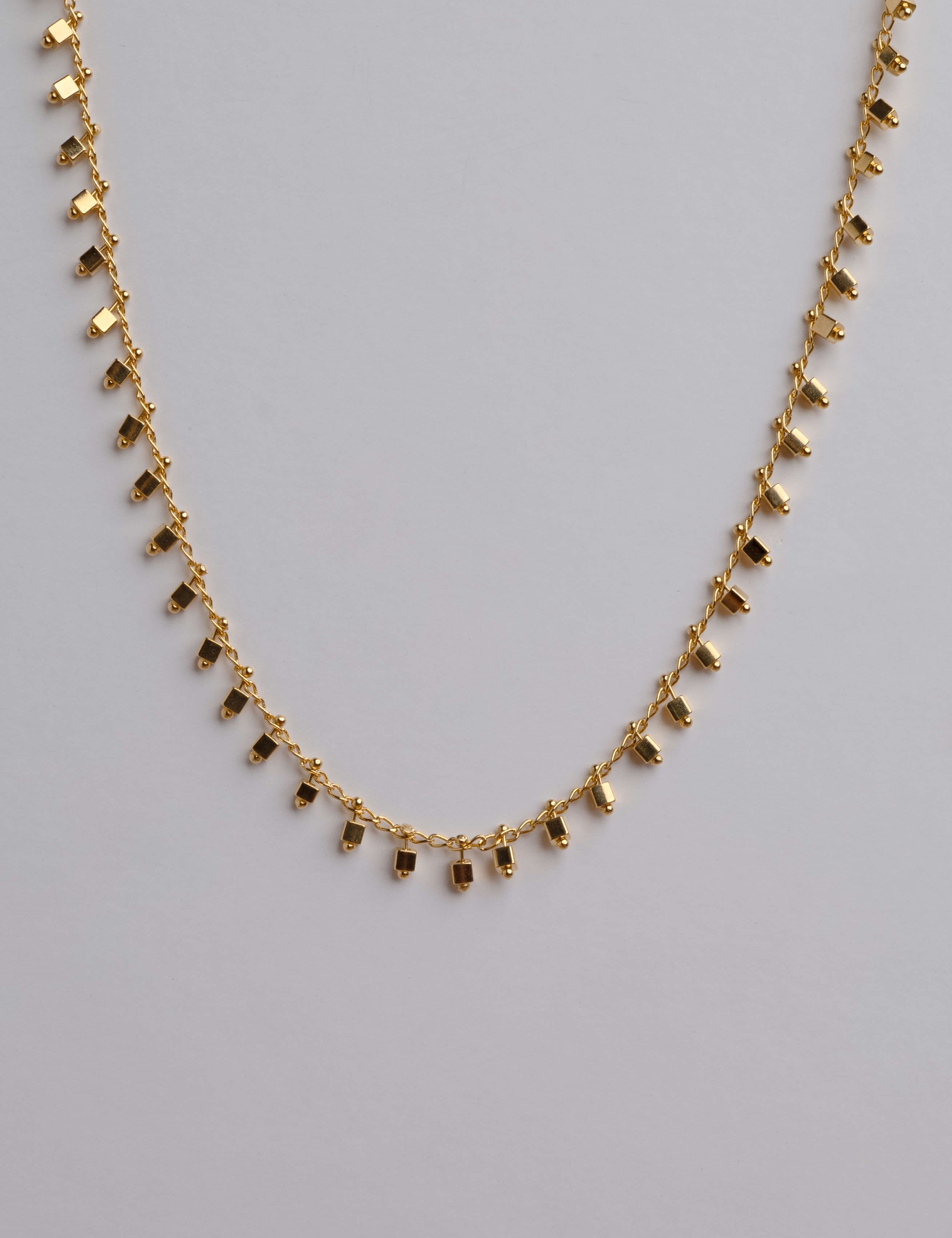 Delicate gold necklace with a minimalist square pendant, 18K gold plated, lightweight and stylish