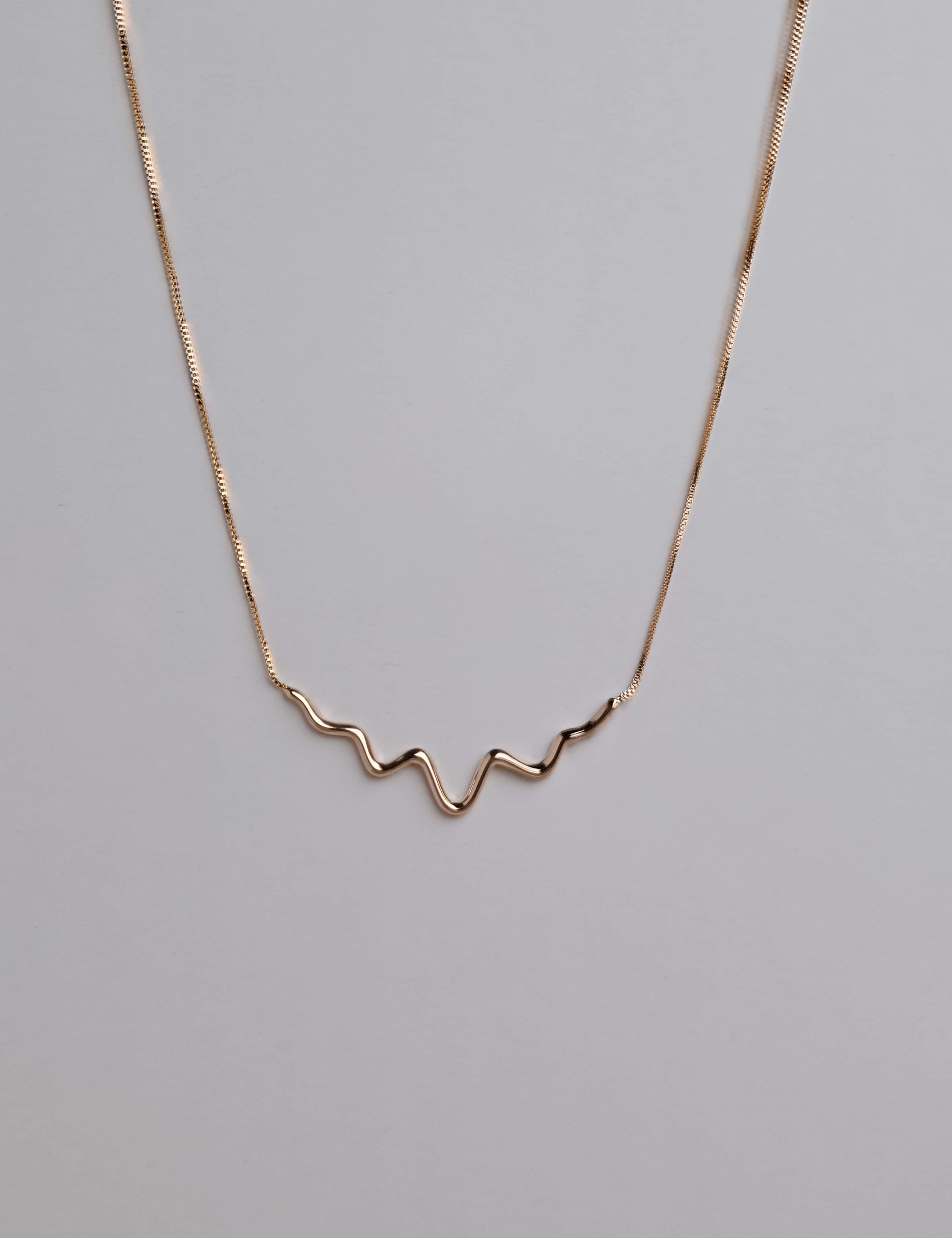 Gold filled wave necklace with a minimalist wavy design, hypoallergenic and non-tarnishing