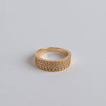 Close-up of chunky gold ring with dazzling zirconia sparkle