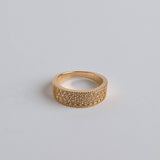 Close-up of chunky gold ring with dazzling zirconia sparkle