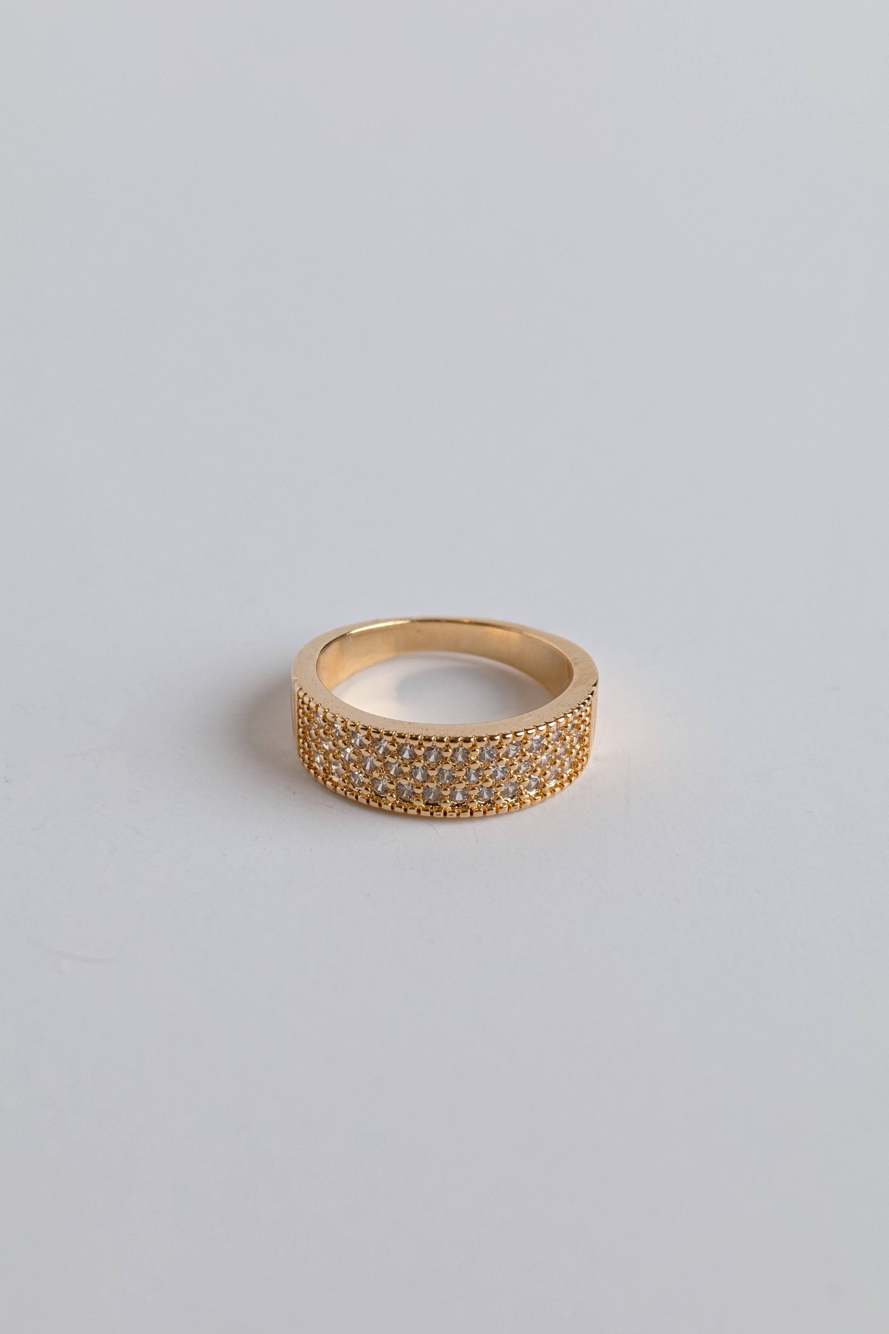 Close-up of chunky gold ring with dazzling zirconia sparkle